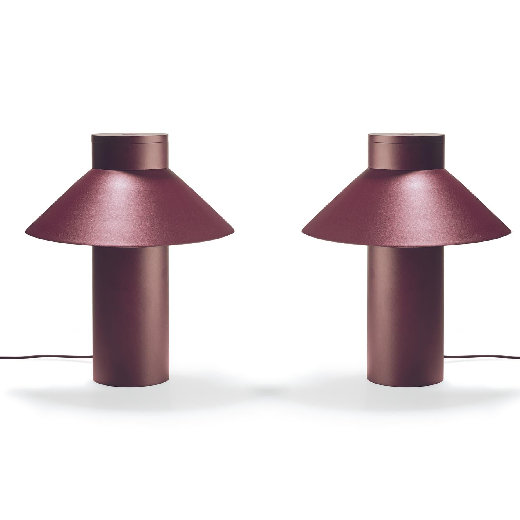 Table lamp designed by Joe Colombo in 1968. 

With its sleek yet optimistic clarity of form; a light, triangular shade seemingly floating off a weighty cylindric base, Italian design icon Joe Colombo’s table lamp nods to Asian heritage, the name