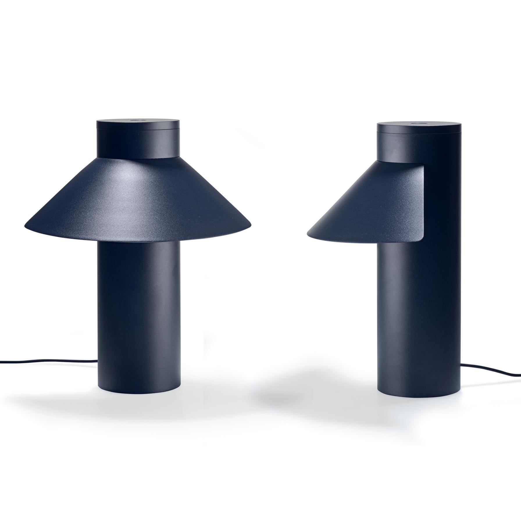 Table lamp designed by Joe Colombo in 1968. 

With its sleek yet optimistic clarity of form; a light, triangular shade seemingly floating off a weighty cylindric base, Italian design icon Joe Colombo’s table lamp nods to Asian heritage, the name