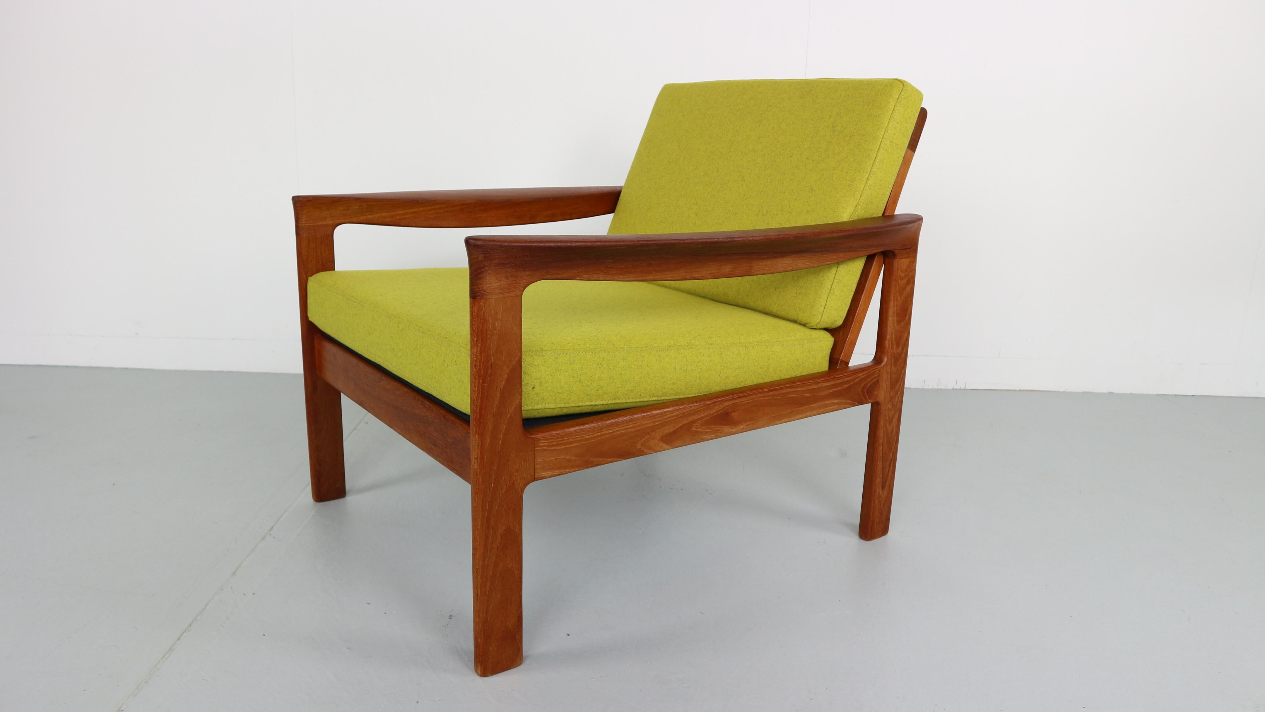 This set of ’Borneo’ lounge chairs ware designed by Sven Ellekaer for Komfort, Denmark in the 1960s. It features a beautiful shaped solid teak frame with new wool upholstery, new webbing and foam. Marked by the maker.