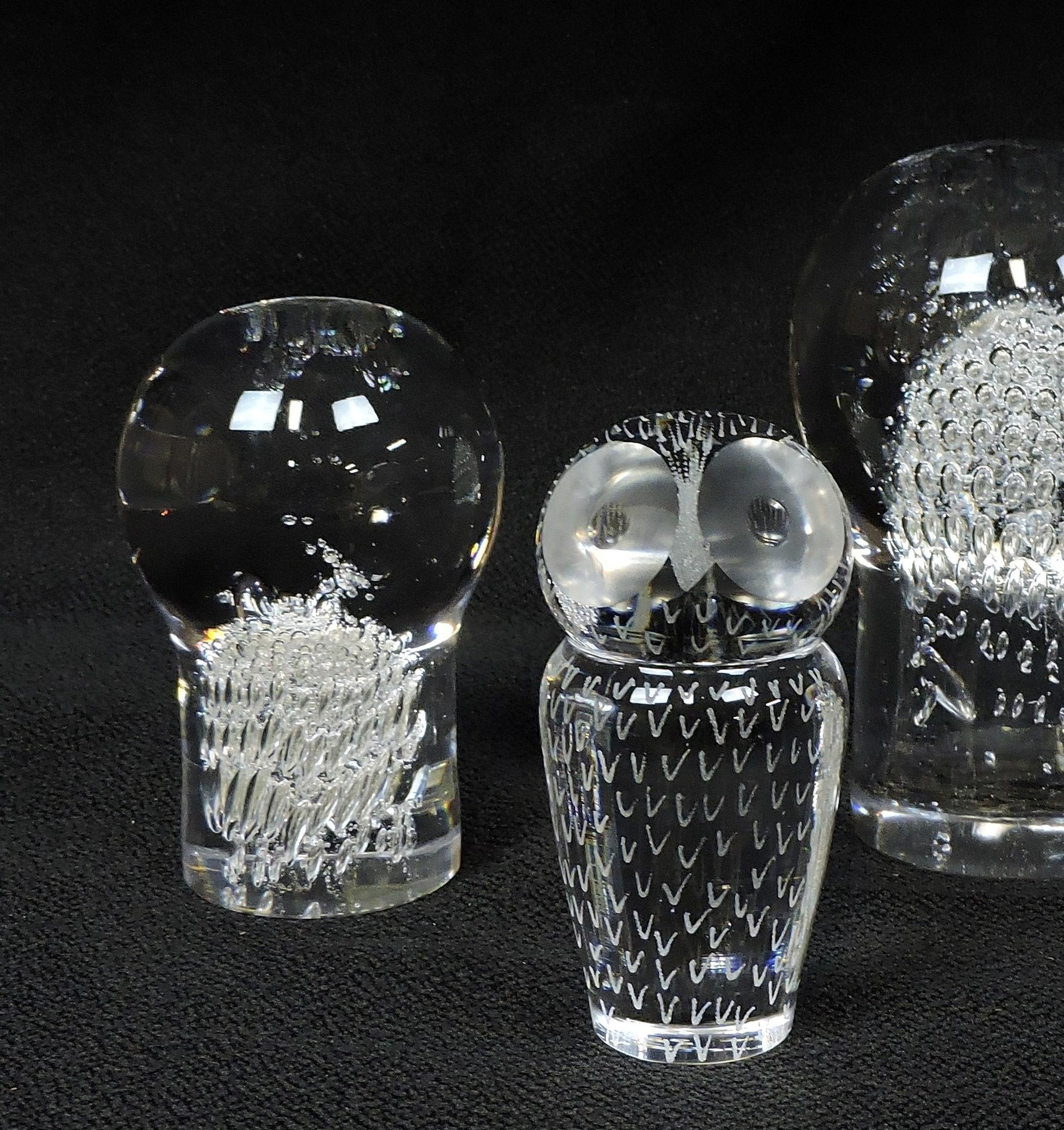 Set of two hand blown clear crystal paperweights by Kosta Boda, Sweden. This set includes one mushroom paperweight designed by Goran Warff, and one owl paperweight designed by Vicke Lindstrand. Both are signed and numbered and the mushroom is also