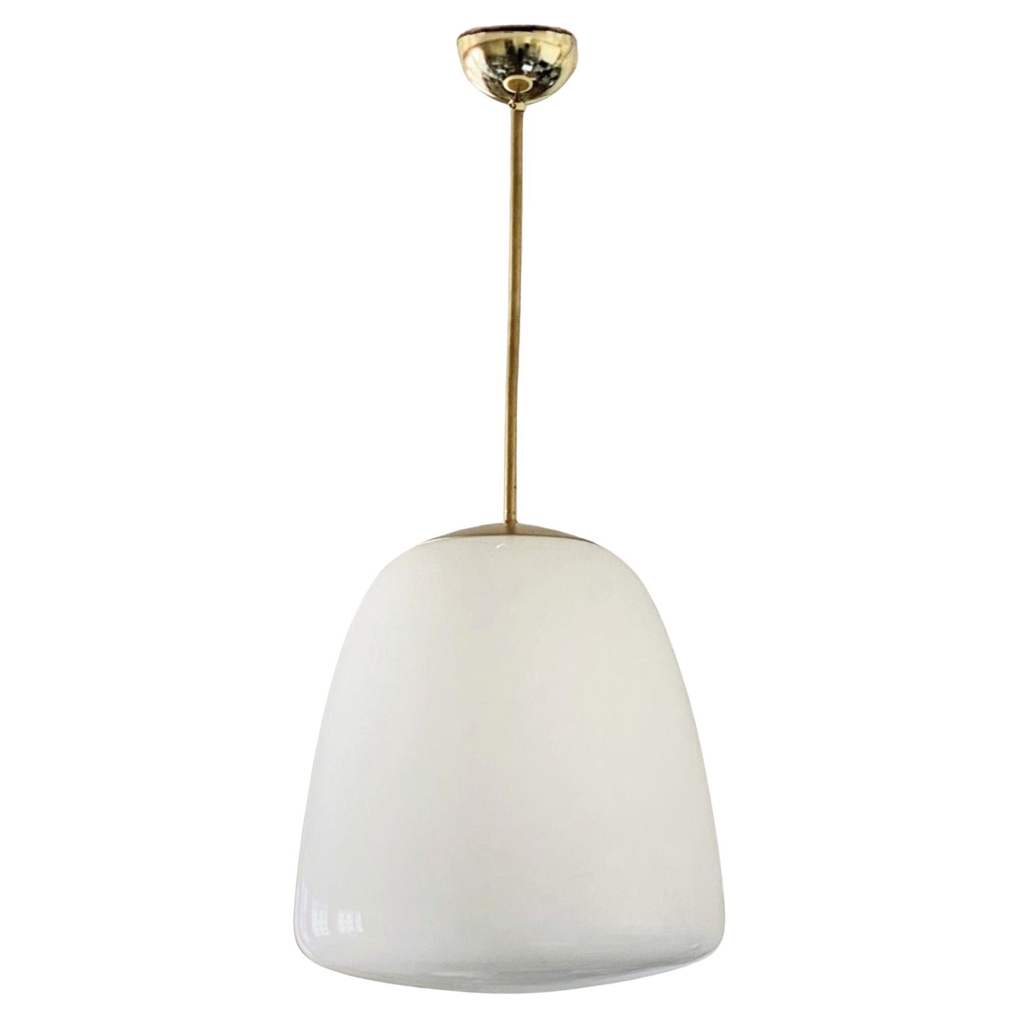 A pair of Bauhaus opaline glass Theatre pendants, Germany, 1930-1939. Large conical shaped thick opaline glass shade brass mounted, with porcelain buld holders. Both pieces In very good condition, glass shades without damages, brass with aged