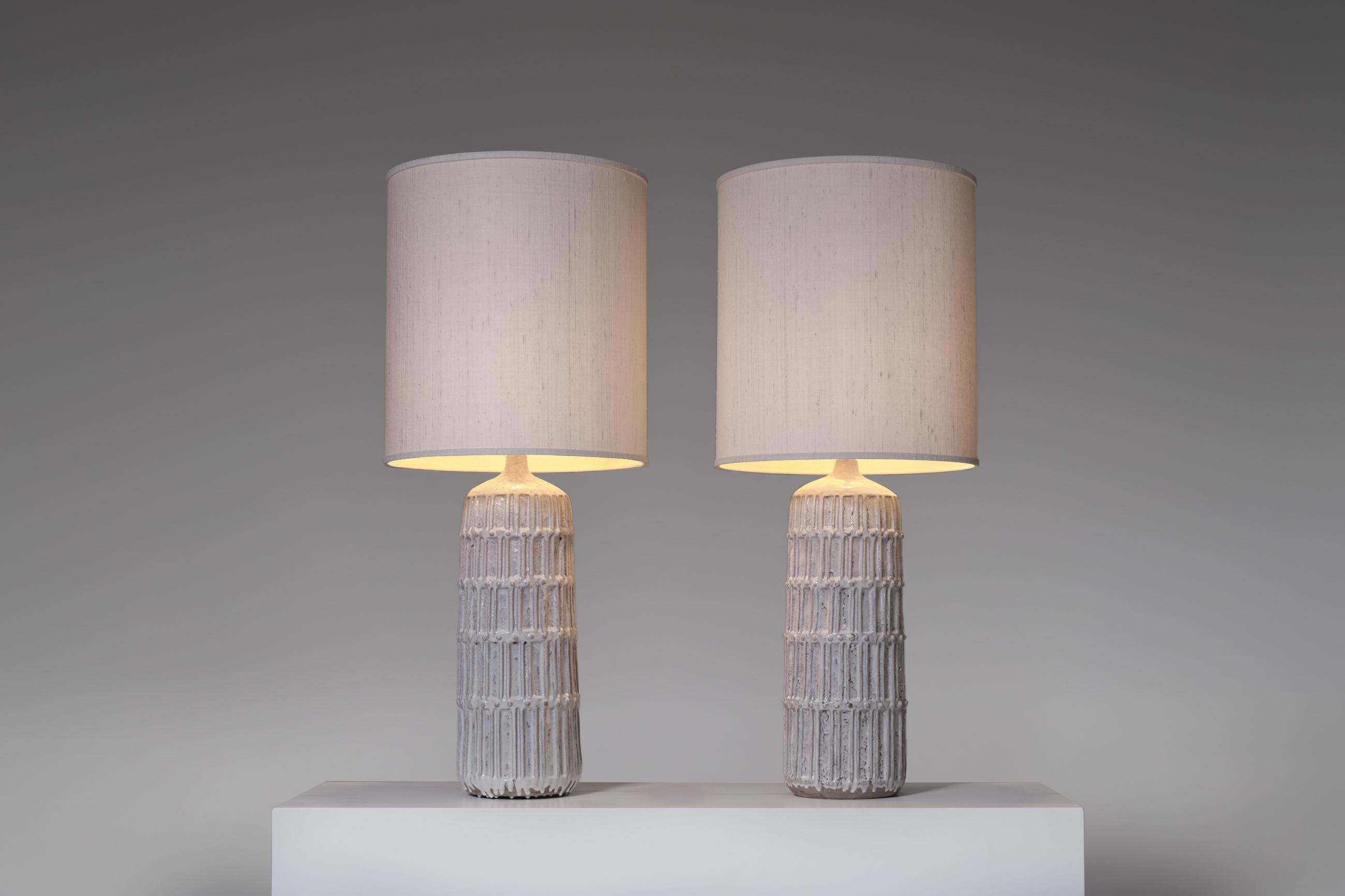 Set of two large Bitossi table lamps, Italy 1960's. Monumental in size with a beautiful rhythmic line and dot decoration with a fantastic thick glaze finish. The shades are custom made in a natural linen, both outside and inside, giving the lamps a