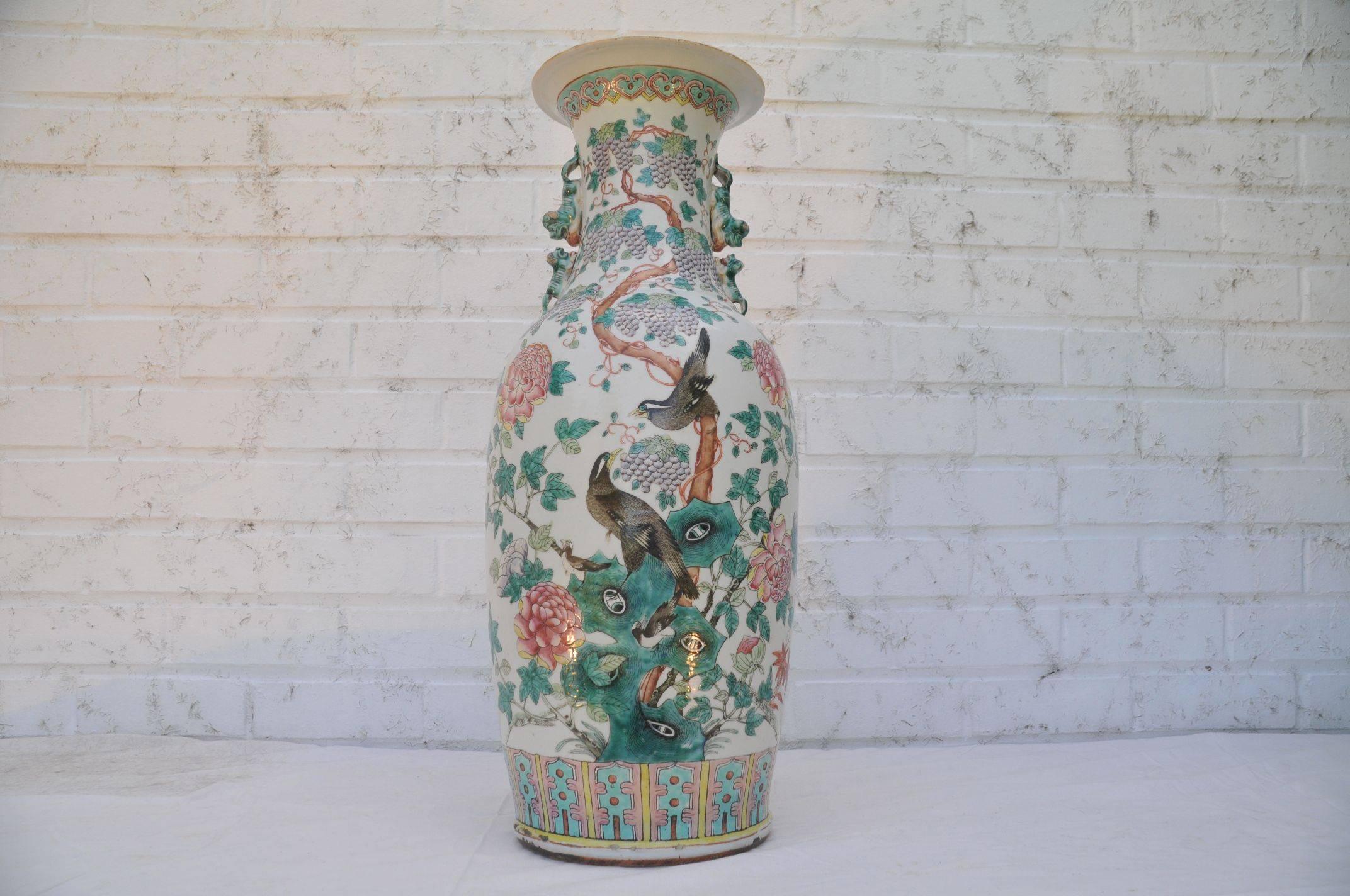 A set of two large Chinese famille rose peacock baluster vases.

Daoguang period, circa 1850. 
The baluster body painted in bright enamels with paradise birds among large red colored flower heads and growing plants and dark green leaves, 
The
