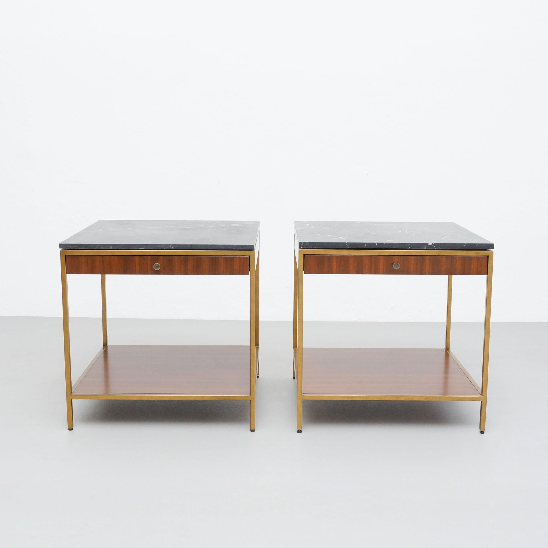 Set of two side tables by unknown designer and manufacturer, circa 2015.
In original condition, with minor wear consistent with age and use, preserving a beautiful patina.

One of the marbles has ben