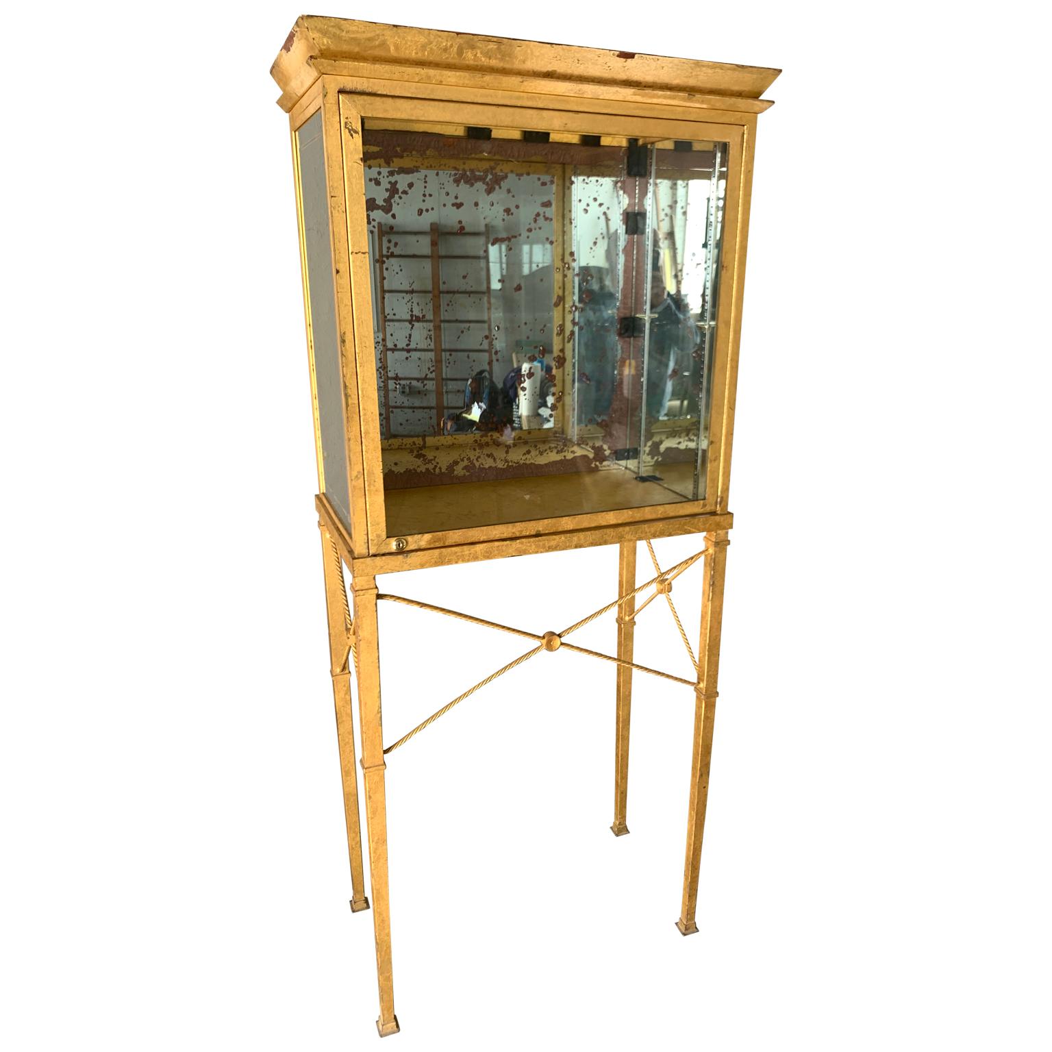 Set of two large custom-made gilted metal and mirror glass display cabinets cases.

Attributed to come from a high end Manhattan retail store, circa 1960.
    