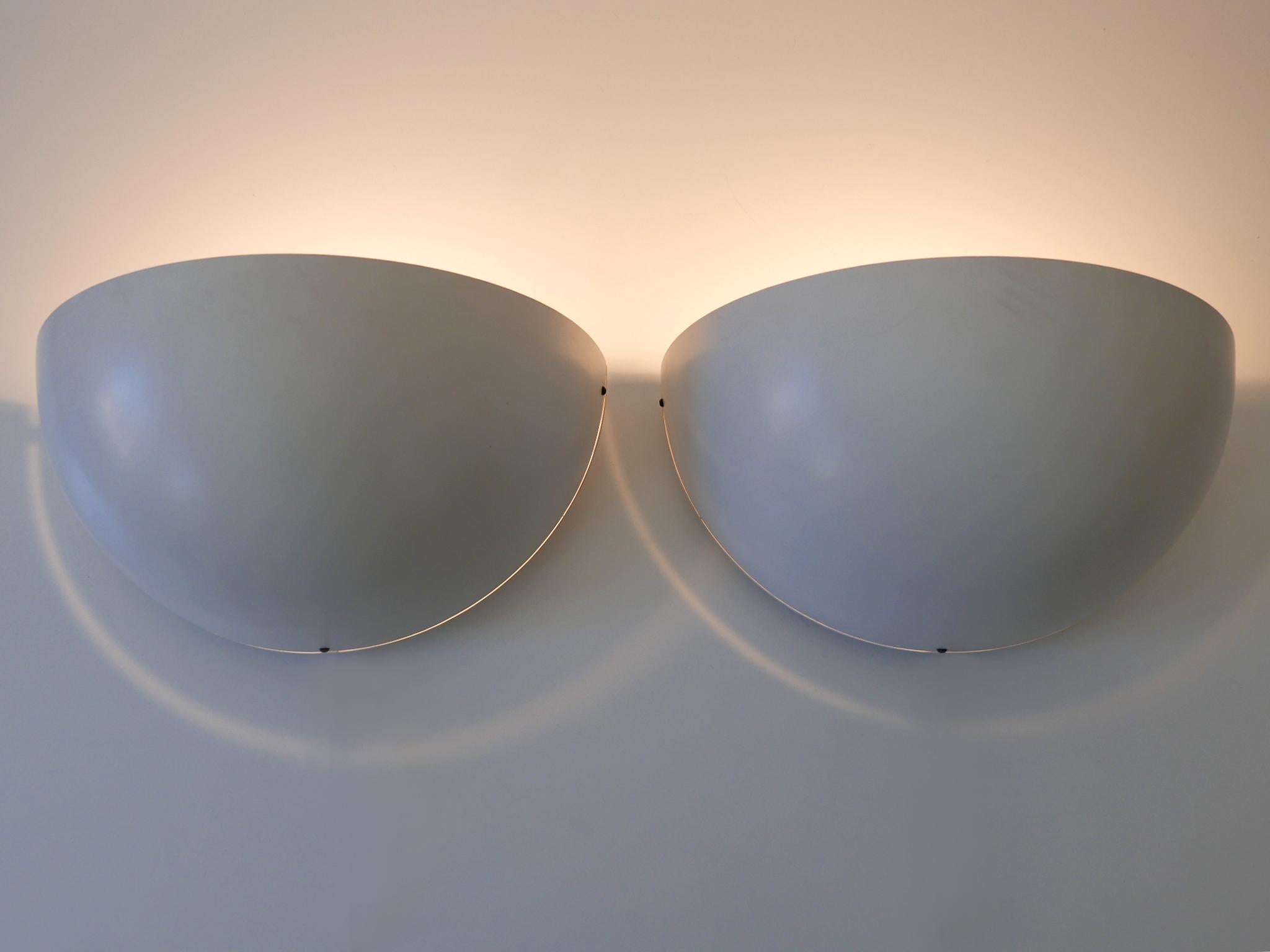 Set of two elegant minimalistic Mid-Century Modern sconces. Designed and manufactured in Germany, 1960s.

Executed in enameled aluminium, each sconce comes with 1 x E27 / E26 Edison screw fit bulb holder, is rewired, in working condition and runs