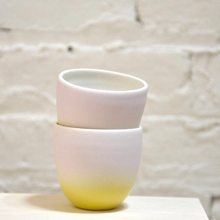 Set of two hand-thrown porcelain tea cups with a modern spray glazed lavender and bright yellow glaze and a matte satin finish. 

Each cup approximately 2 1/2