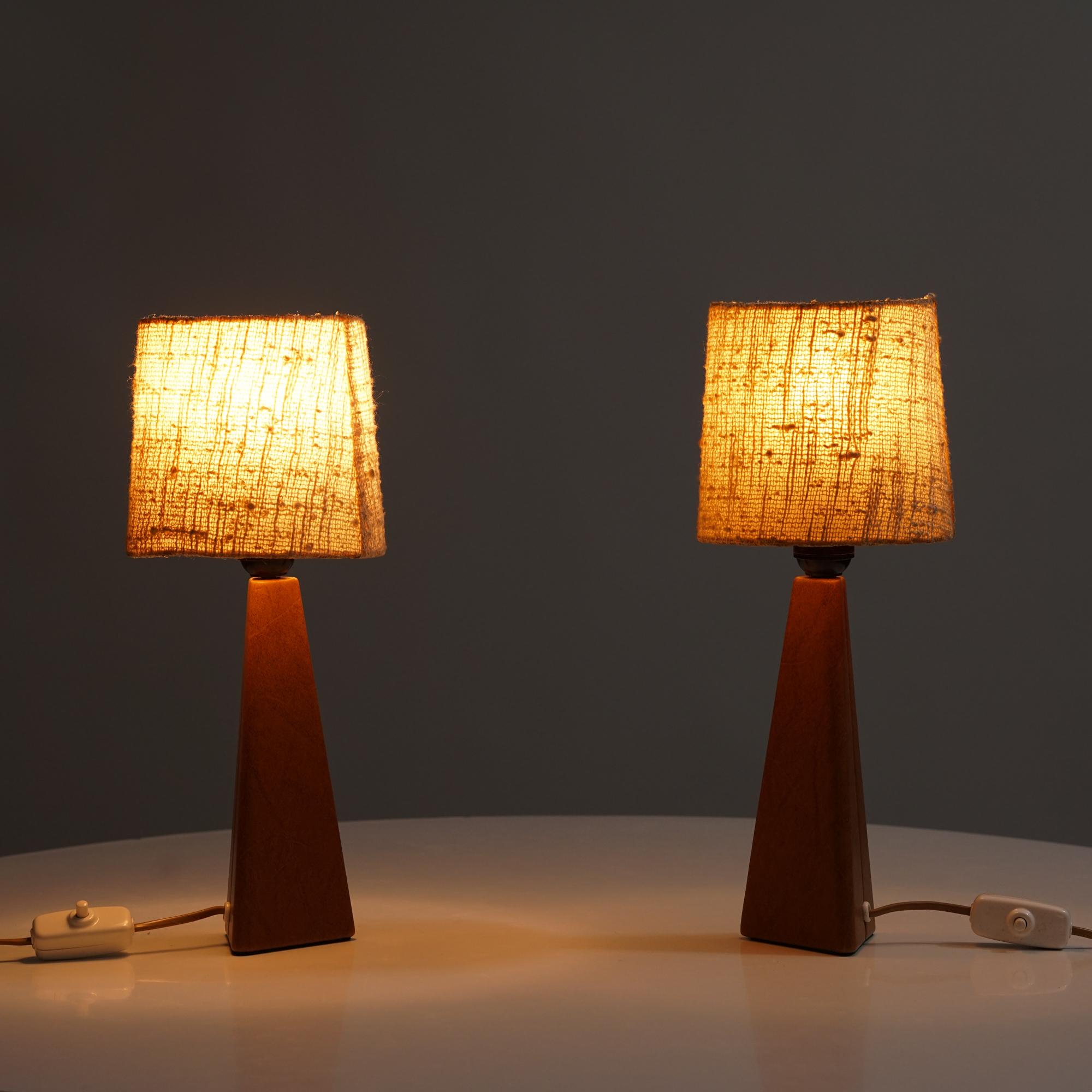 Set of two leather table lamps by Lisa Johansson-Pape for Orno, Mid-20th Century. Leather frame with fabric lampshades. The lampshades are not original. Good vintage condition, minor patina and wear consistent with age and use. The table lamps are