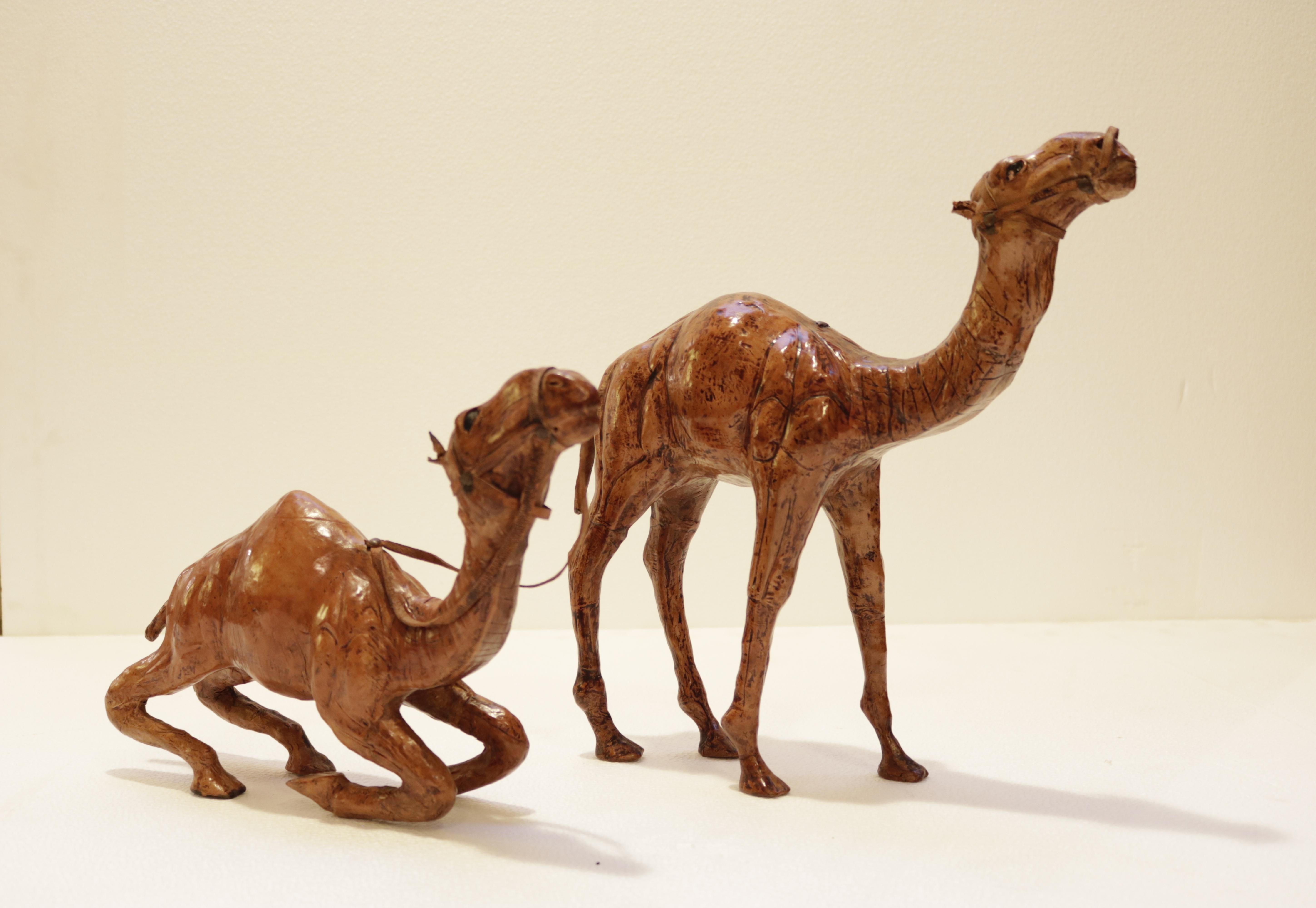 Set of leather wrapped Moroccan handcrafted camel sculptures. 
The standing camel measures W 14