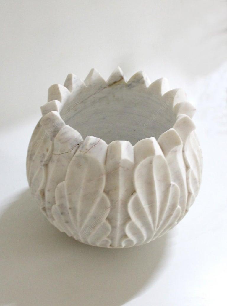 Hand carved out of a single block of marble, perfect for outdoors.

Lotus pots in white marble
Size- 17