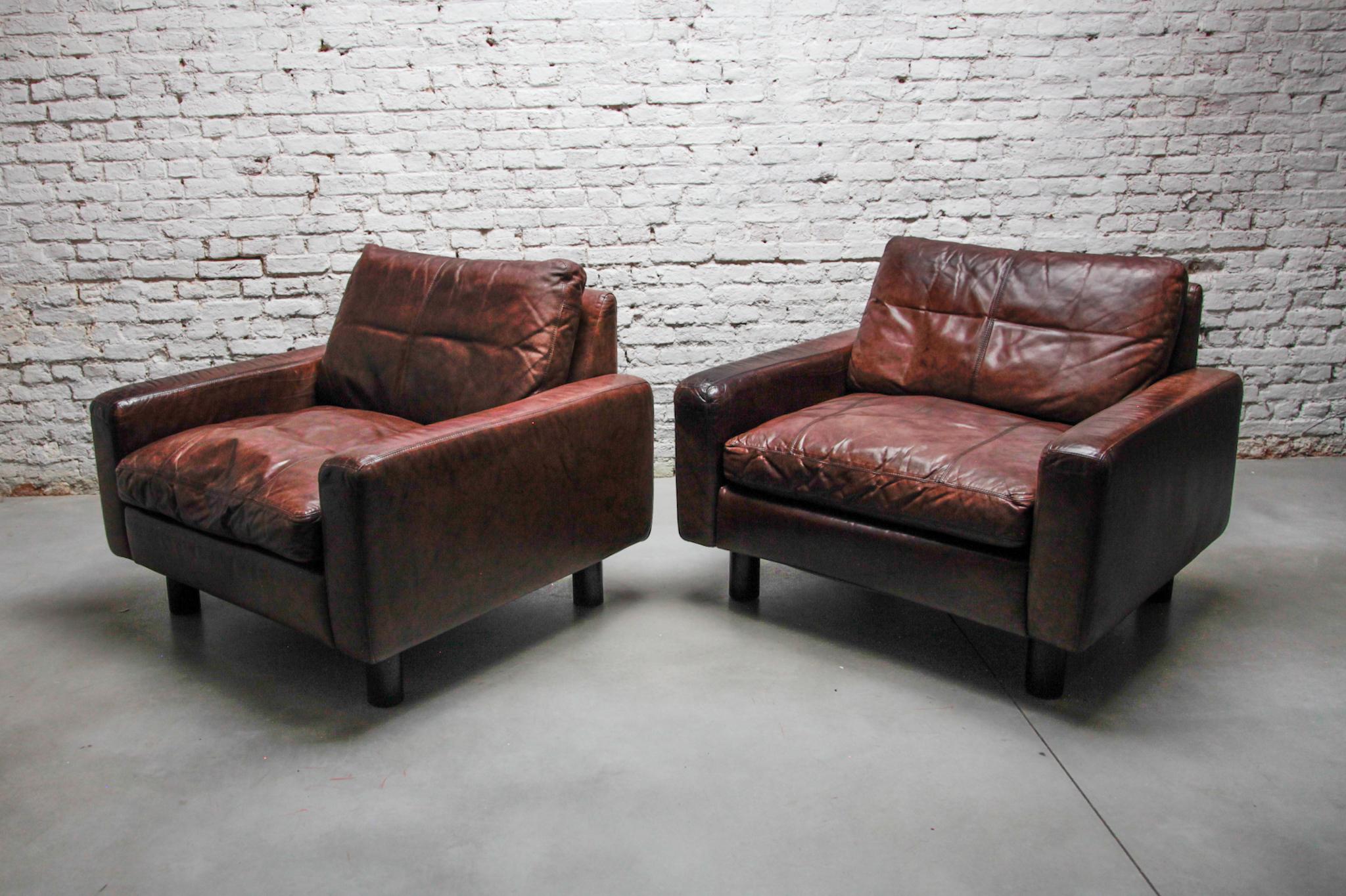 Comfortable set of two brown, grey leather lounge arm chairs designed manufactured by COR Germany, 1972. These brown, grey leather lounge chairs seats very comfortable and relaxing, the leather has a nice patina from age and usage. Also a matching