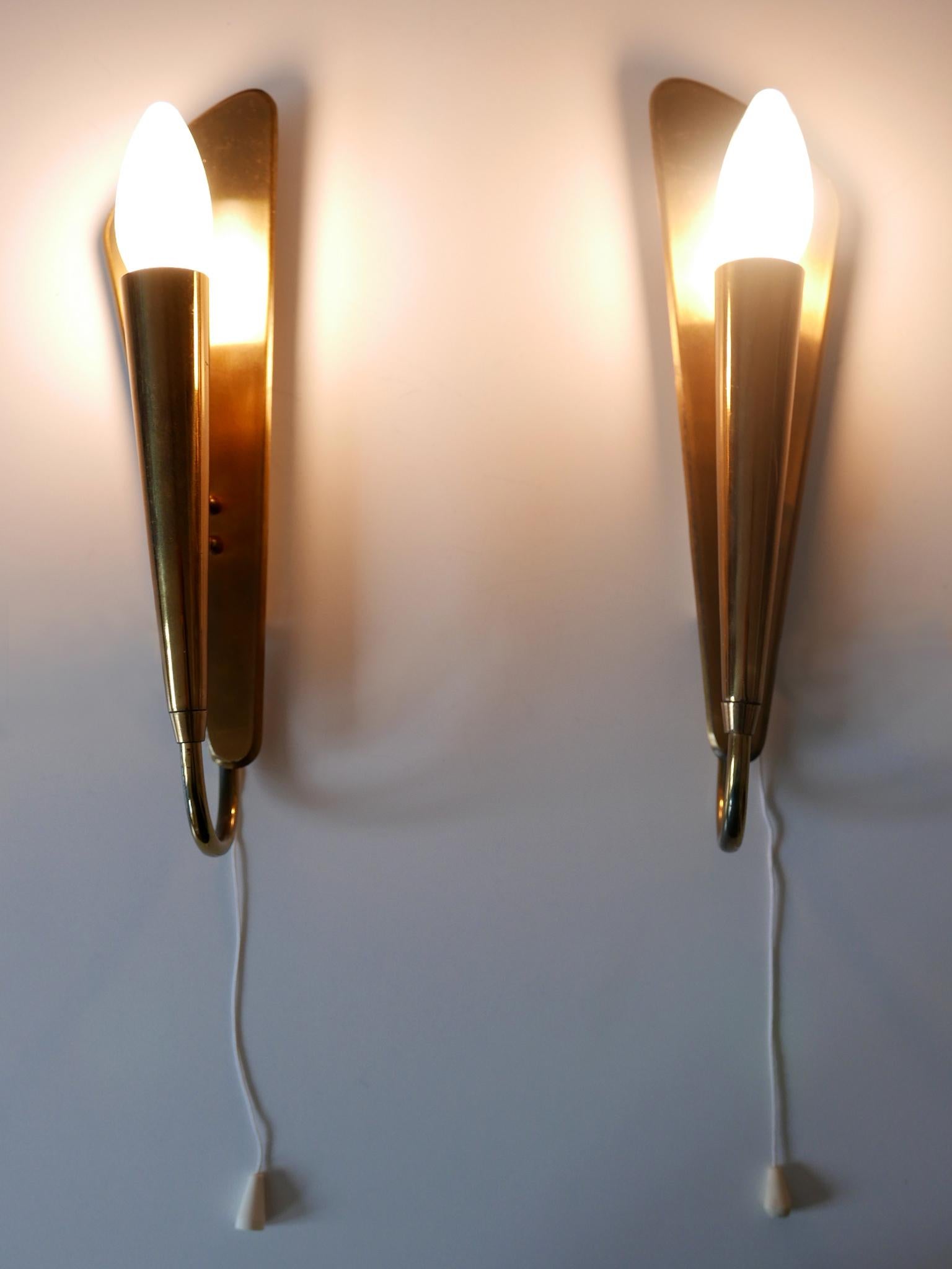 Set of two elegant and highly decorative Mid-Century Modern sconces or wall fixtures. Designed & manufactured in Germany, 1950s.

Executed in brass sheet and tubes, each fixture is executed with 1 x E14 / E12 Edison screw fit bulb socket, is wired