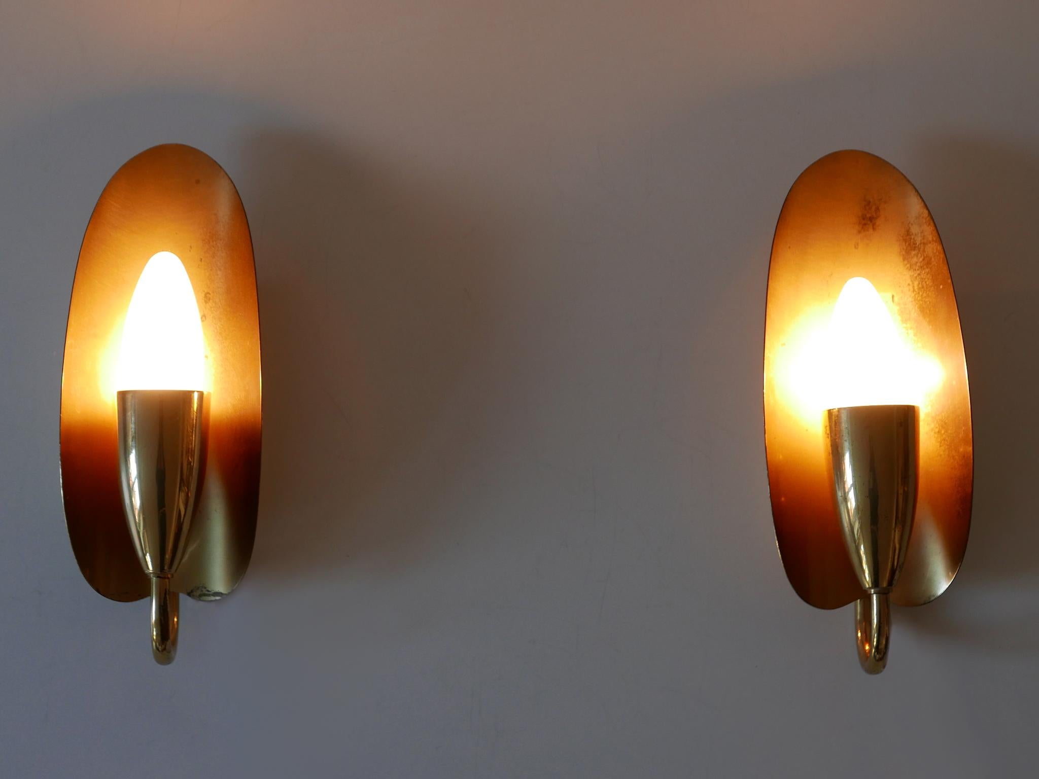 Set of two elegant and highly decorative Mid-Century Modern sconces or wall fixtures by Kaiser Leuchten, Germany, 1950s.

A total of 23 sets of two available!

Executed in brass sheet and tubes, each fixture is executed with 1 x E14 / E12 Edison
