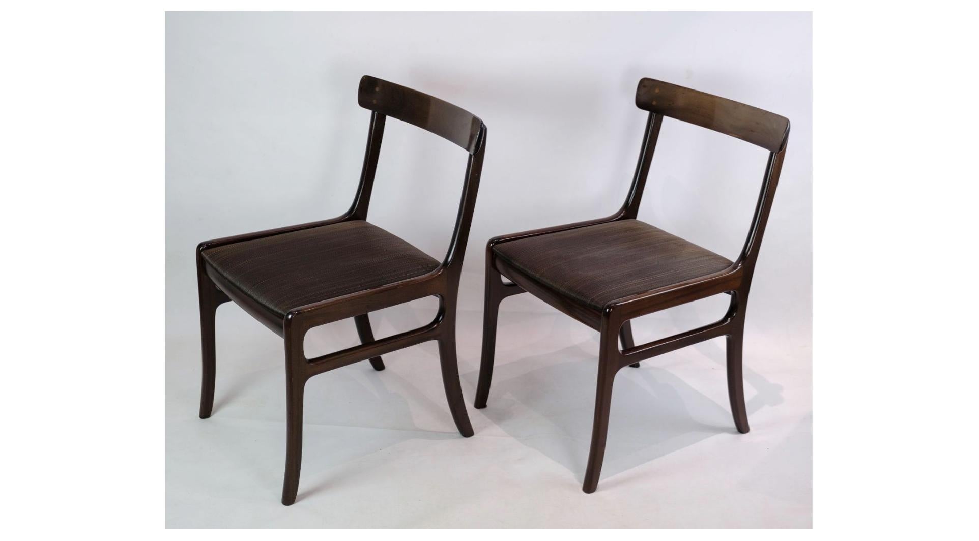 A pair of Rungstedlund mahogany dining chairs, designed by Ole Wanscher and manufactured by P. Jeppesen, is a beautiful example of timeless Danish design. These chairs exude a sublime elegance and simplicity that will add a warm atmosphere to any