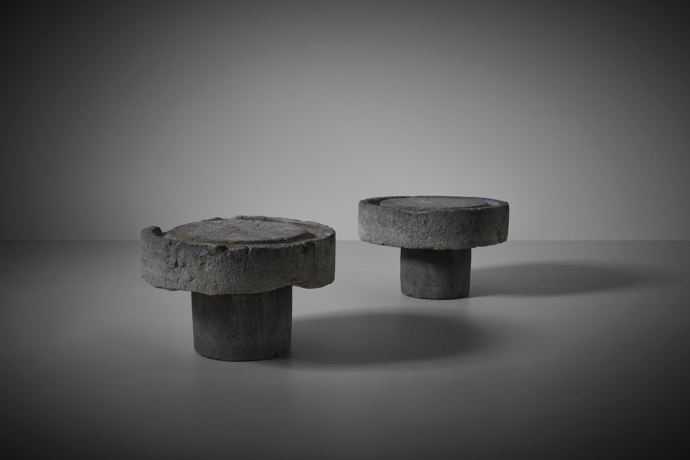 Set of two heavy solid marble cylindrical side tables, France 19th century. Wonderful decorative tables full of character. The stones where originally used as millstones for the extraction of olive oil and gained a wonderful patina due to their