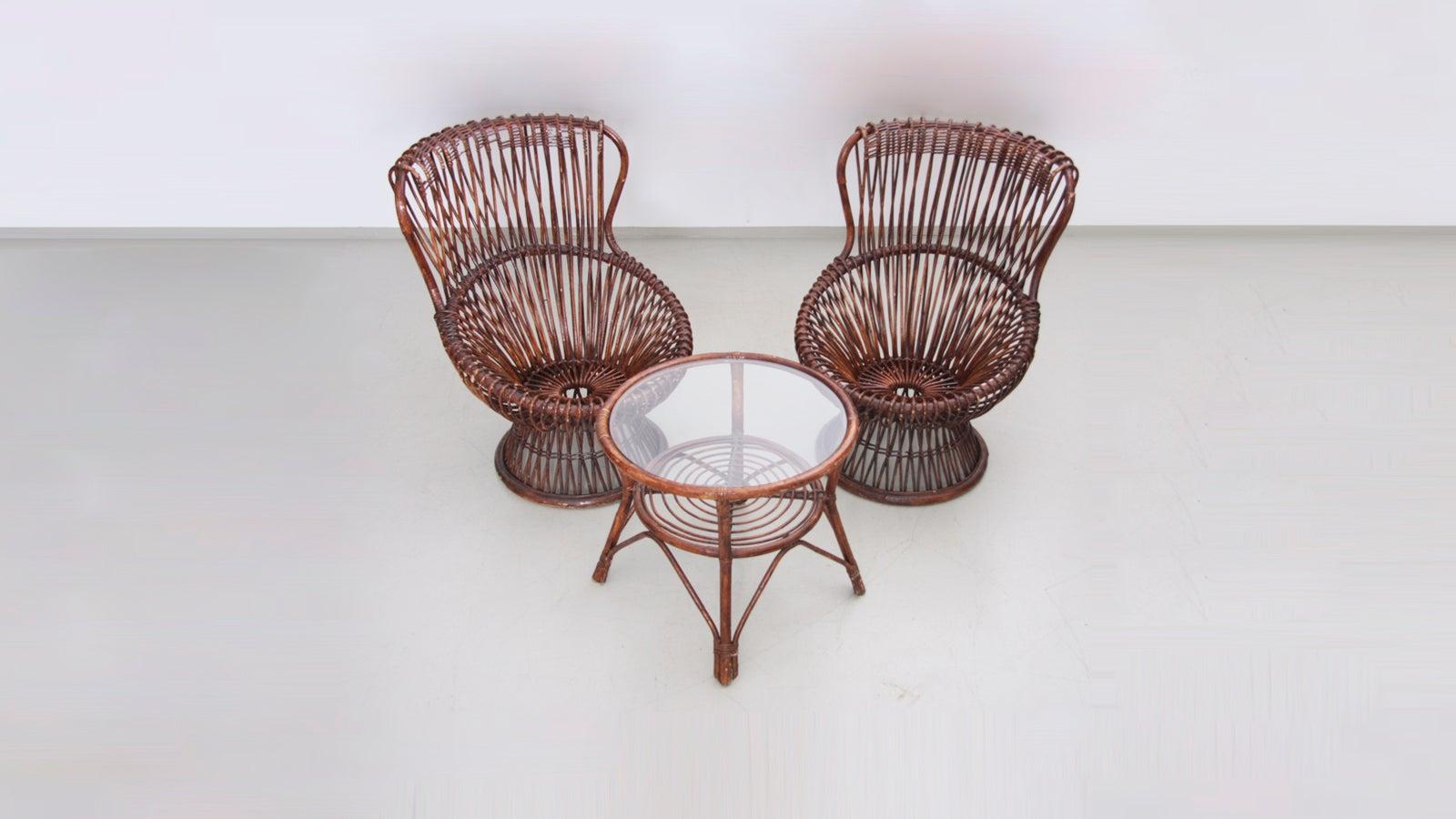 Rare set of two armchairs with rattan frame. Small round table available with glass top.


