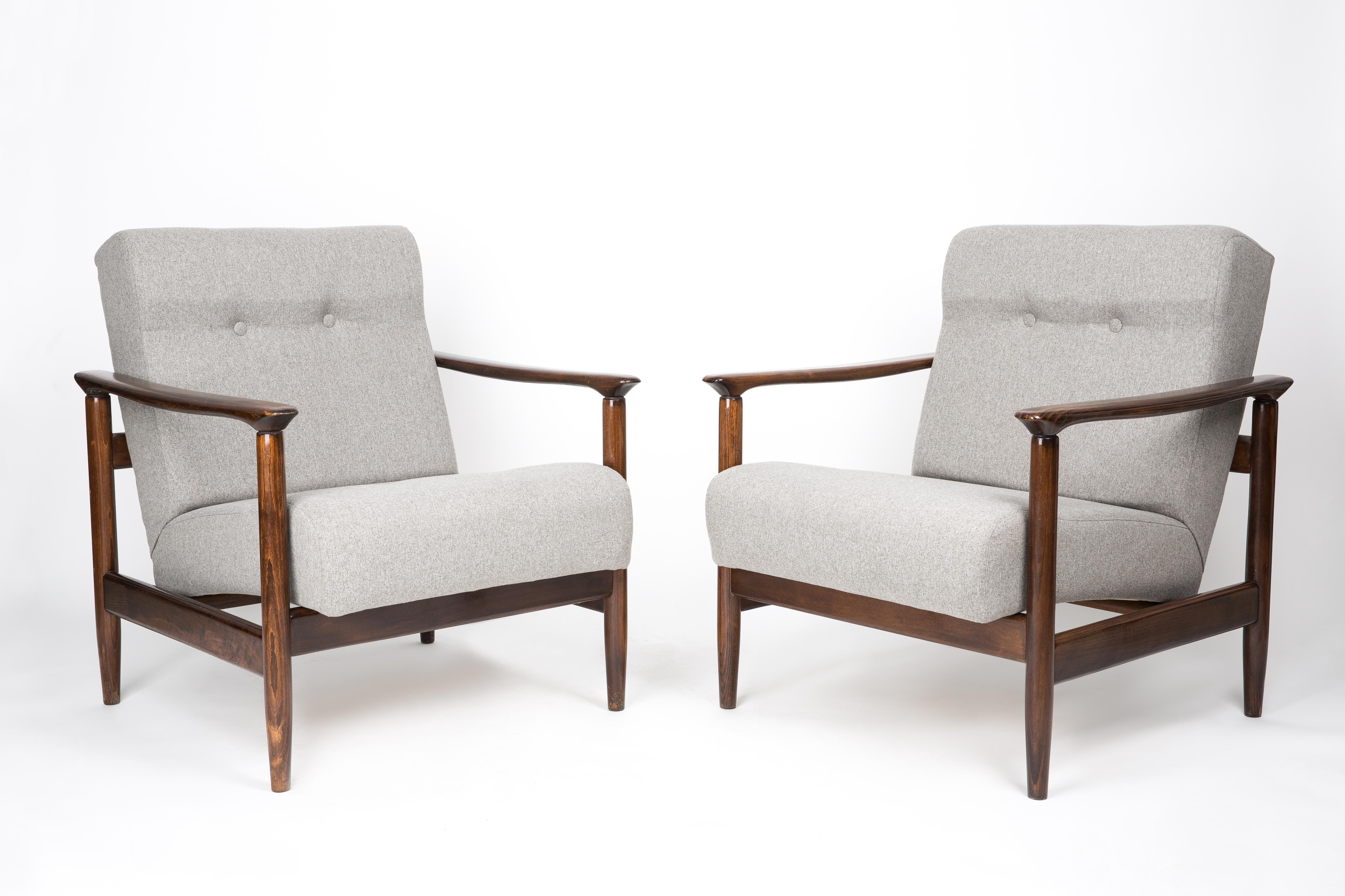 A pair of mid century armchairs GFM-142, designed by Edmund Homa. The armchairs were made in the 1960s in the Gosciecinska Furniture Factory. They are made from solid beech wood. The GFM-142 armchair is regarded one of the best Polish armchair