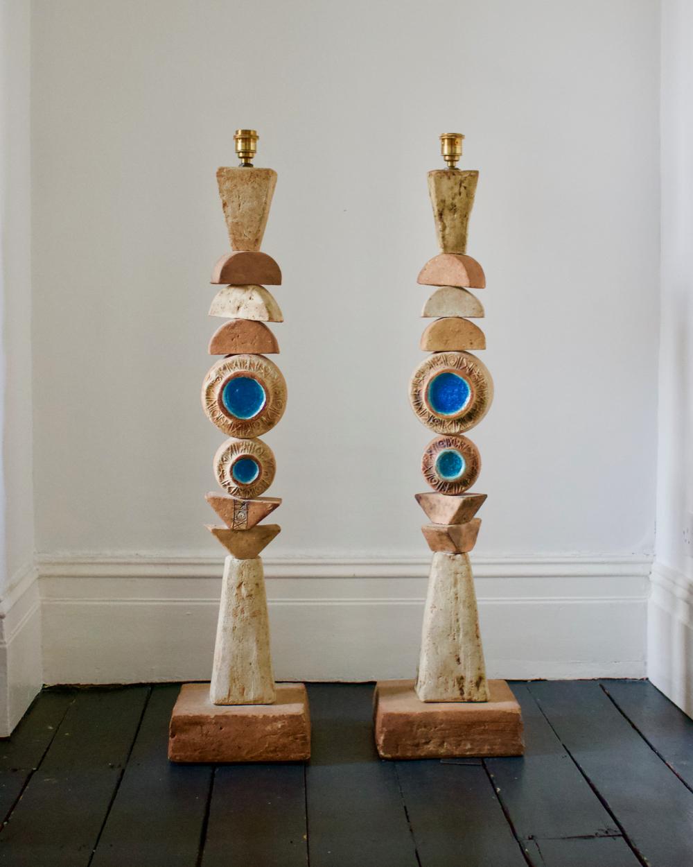 A set of two monumental mid-century Toem floor lamps by English ceramicist Bernard Rooke.

Two beautiful pieces of sculptural studio pottery - both of the same design - made up of ceramic elements in natural tones of terracotta and stone on a
