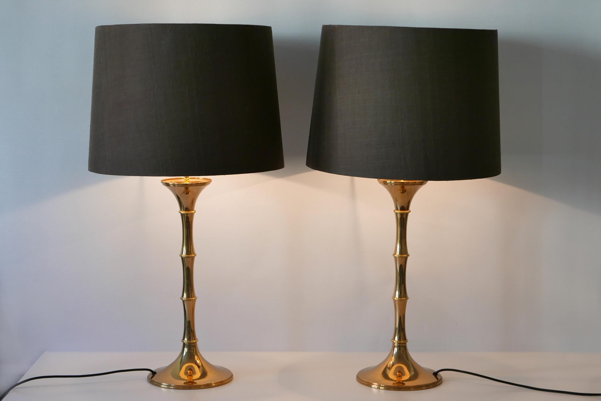 Set of two elegant Mid-Century Modern brass bamboo table lamps. Model 'ML 1'. Designed by Ingo Maurer, 1968 for Design M, Munich, Germany.

Executed in brass tube and sheet, purple-brown silk fabric shade (one is slightly darker), each lamp comes
