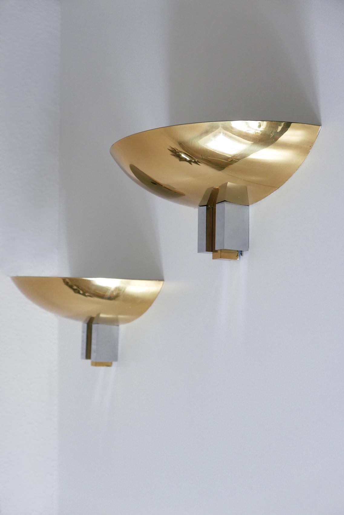 Set of two elegant Mid-Century Modern wall lamps or sconces in Art Deco design. Manufactured by Art-Line Wohndecor, 1980s, Cologne, Germany

Executed in polished brass. Each lamp needs two x E14 Edison screw fit bulbs. They are wired, and run both