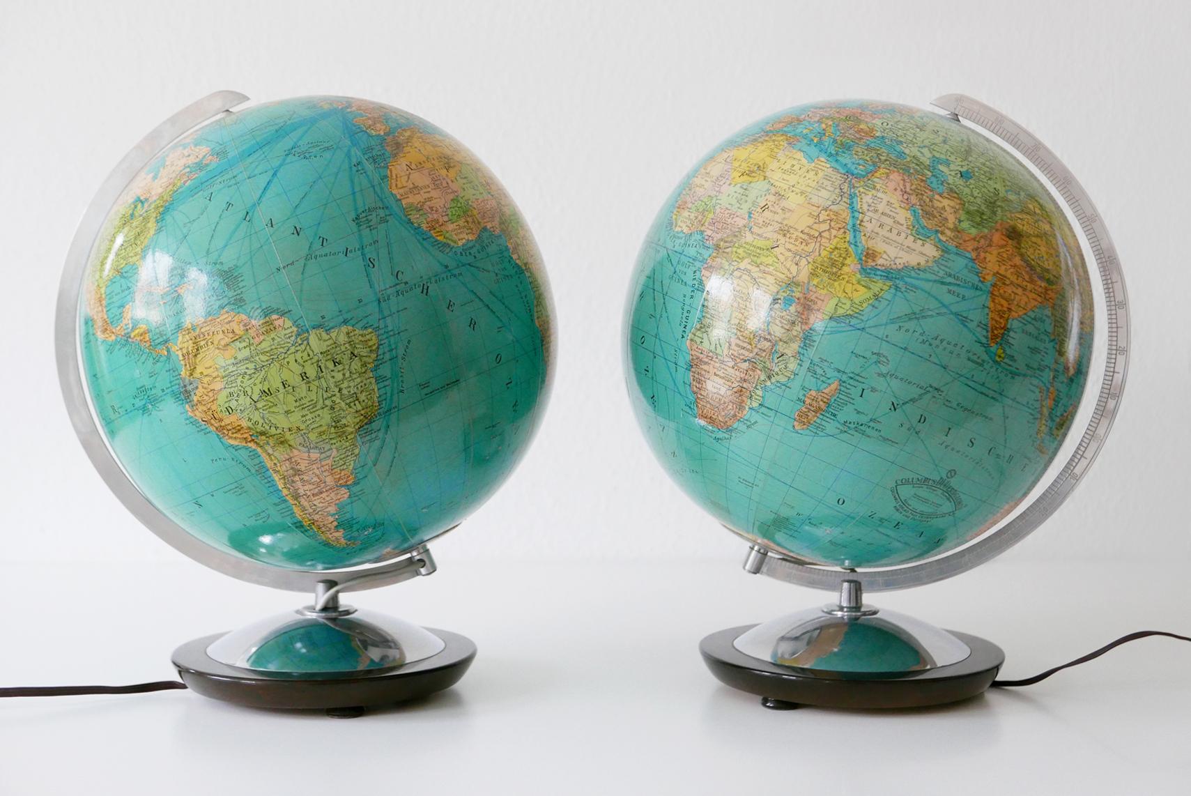 Set of two Mid-Century Modern duo earth globes or side table lamps. Manufactured by Columbus Verlag, Berlin and Stuttgart, 1960s, Germany. The globes are illuminated, and can be used as side table lamps.

Executed in glass, aluminium and wood. The