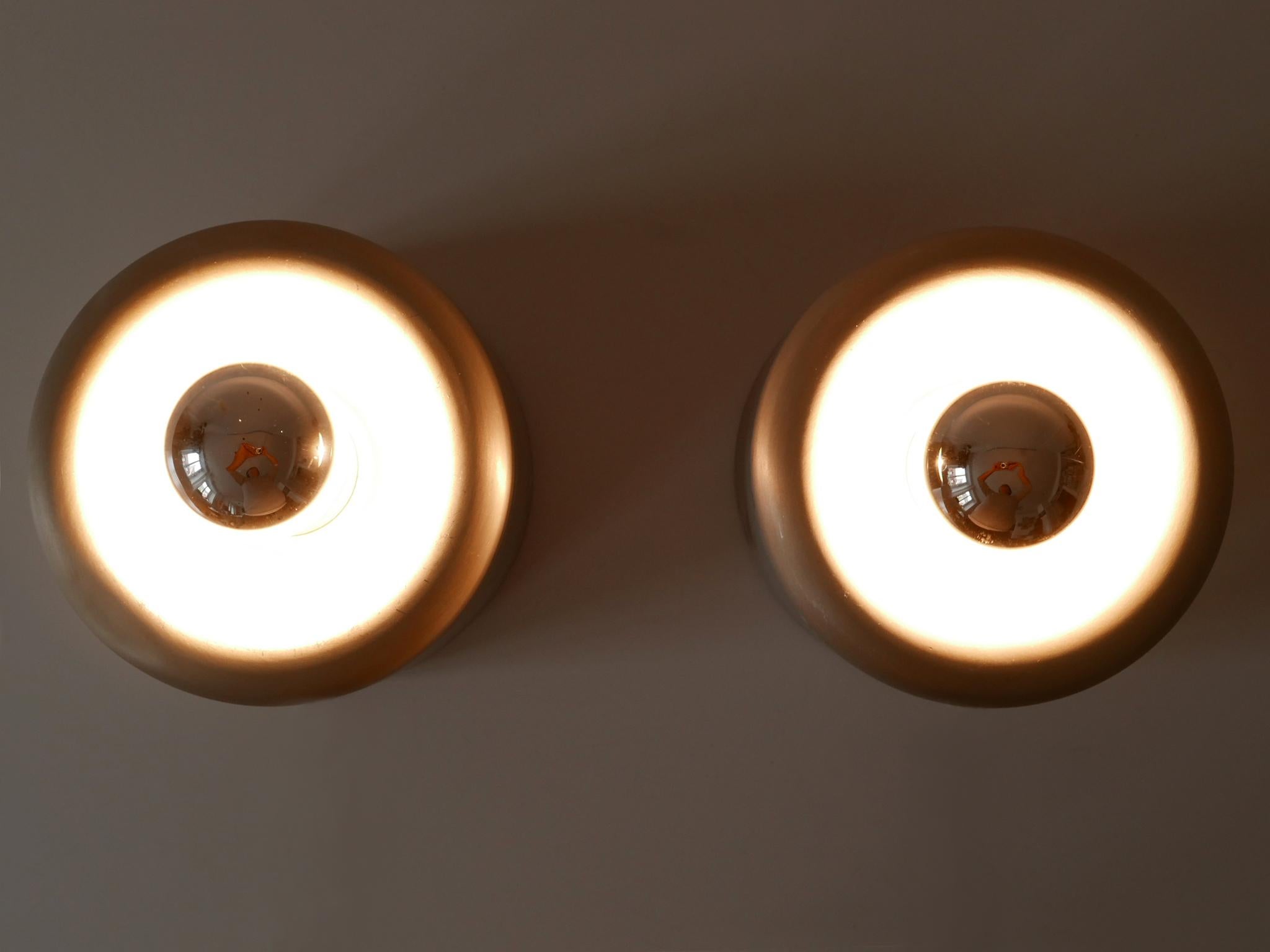 Set of two elegant mid century modern donut flush mounts / sconces. Designed & manufactured by Staff Leuchten, Germany, 1970s. Manufacturers label on the bulb holder.

Executed in aluminium and metal, the fixture is executed with 1 x E27 / E26