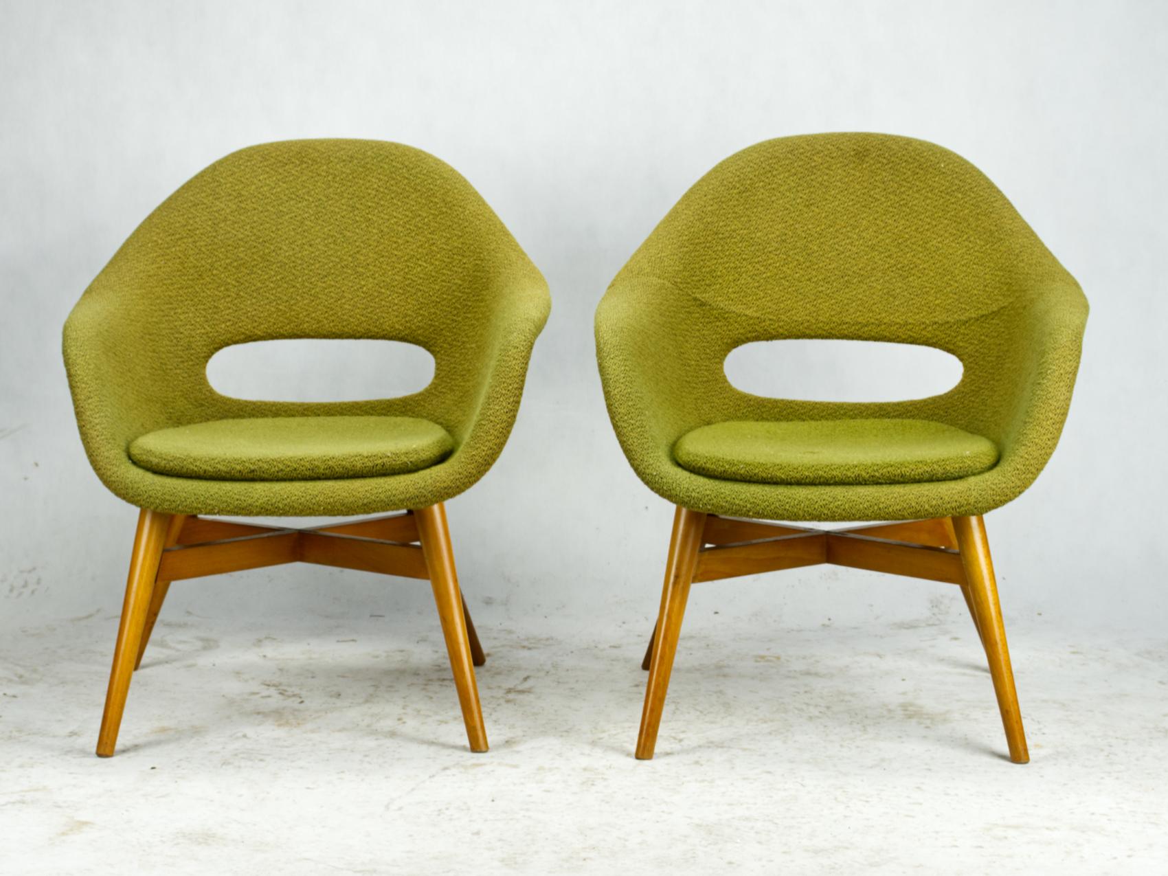 Beautiful set of two easy chairs by Miroslav Navratil, manufactured in Czechoslovakia by Cesky Nabytek, circa 1960.

The chairs have a beech plywood base and a fiber glass shell with original green fabric upholstery. They are rare symbolic pieces