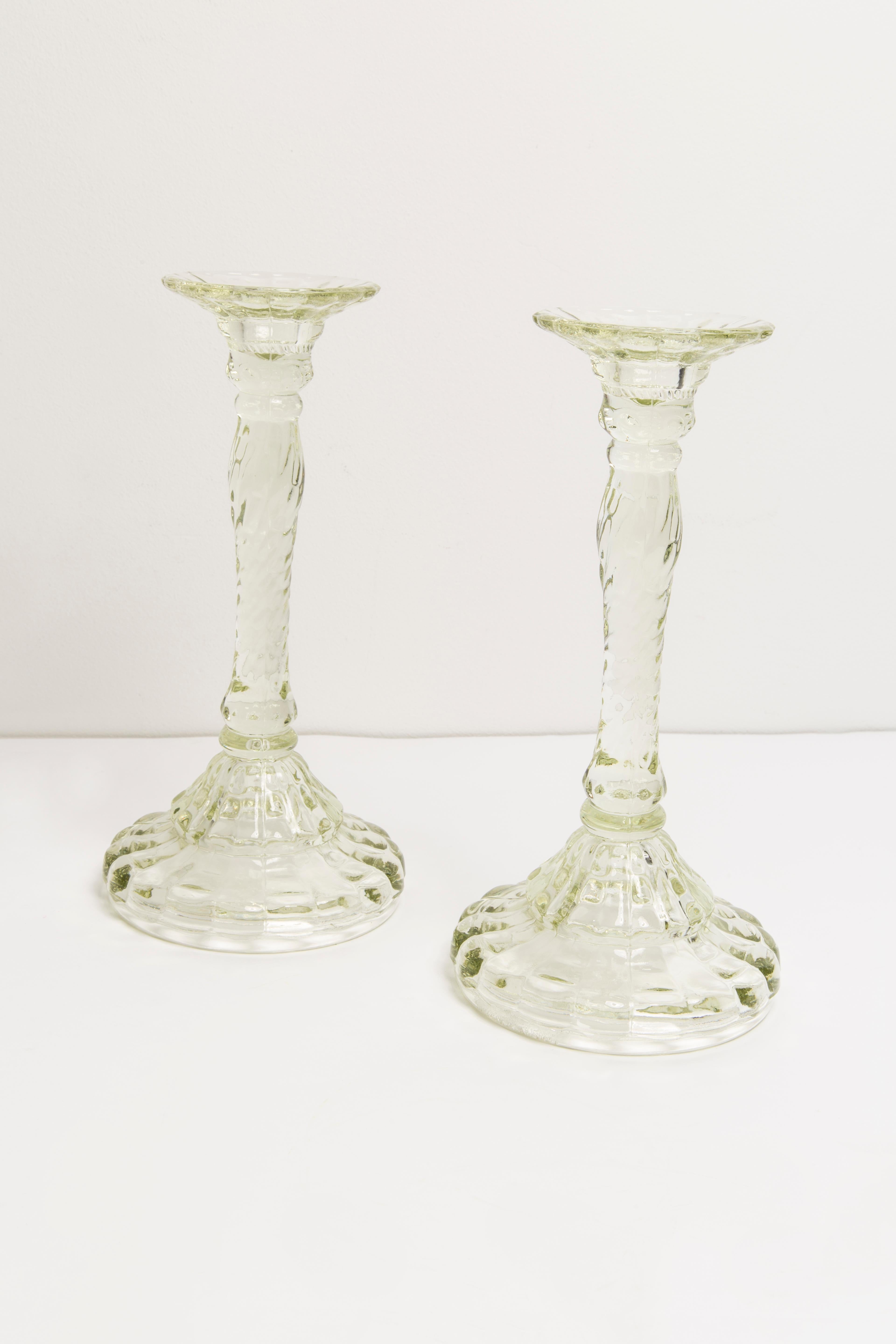 Set of two midcentury Polish modern glass candlesticks, circa 1960. 
Very good condition. No damages. Beautiful light green glass.