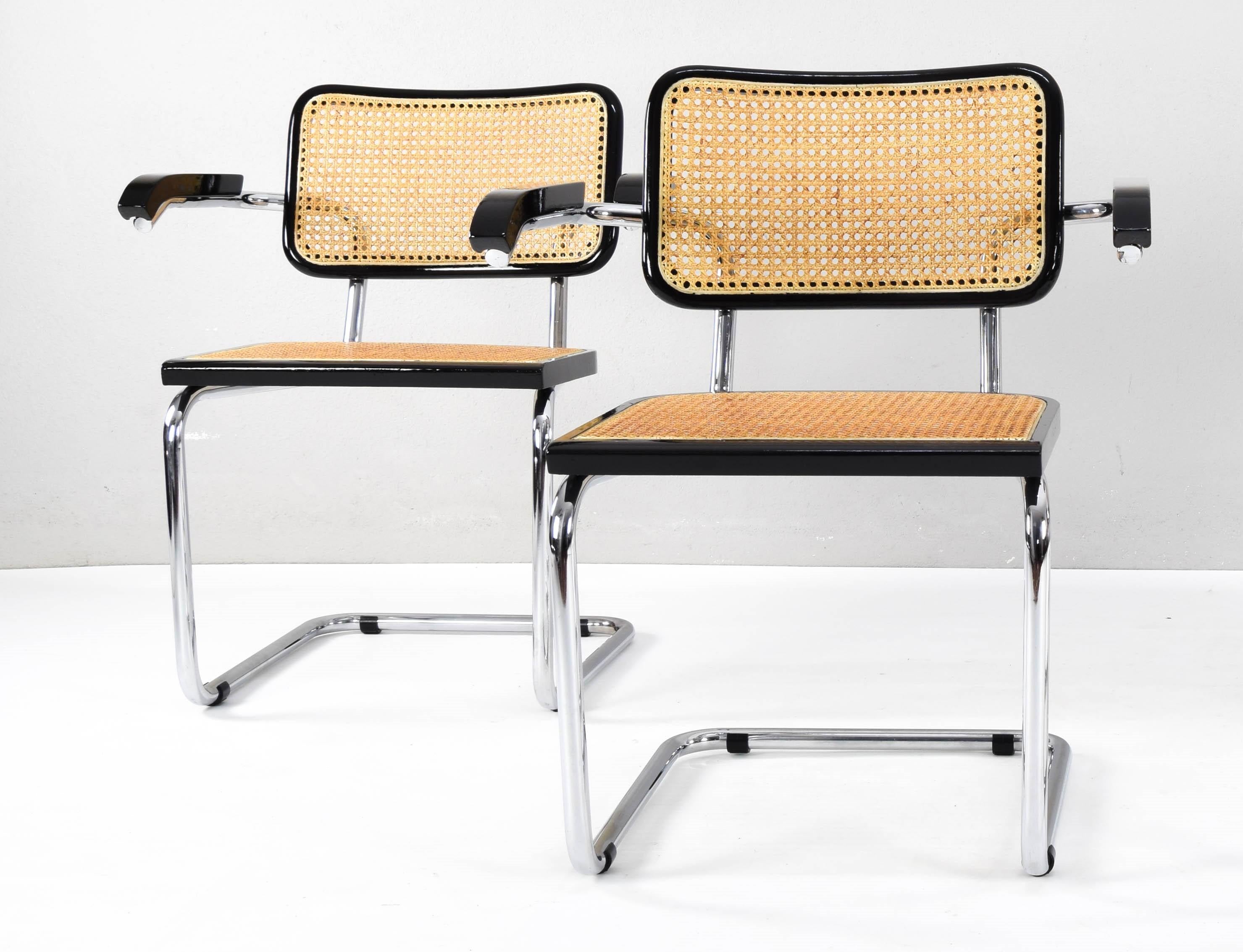 Beautiful and iconic set of two Cesca chairs, model B64, edition with armrests, made in Italy in the 70s.
Chromed tubular structure with worn areas but in good condition.
The backrest and seat structure is made of black lacquered beech wood and