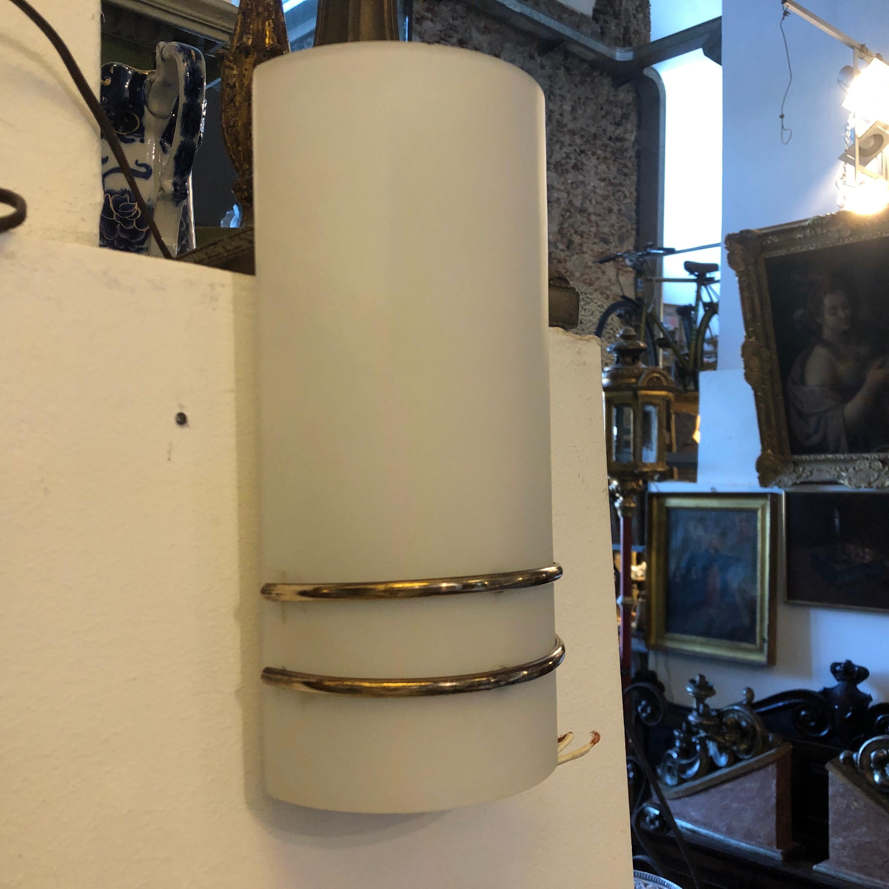 A pair of Mid-Century Modern wall sconces attributed to Stilux, glasses are in perfect conditions, brass is in original patina. They work 110-240 volts and need regular e14 bulbs.