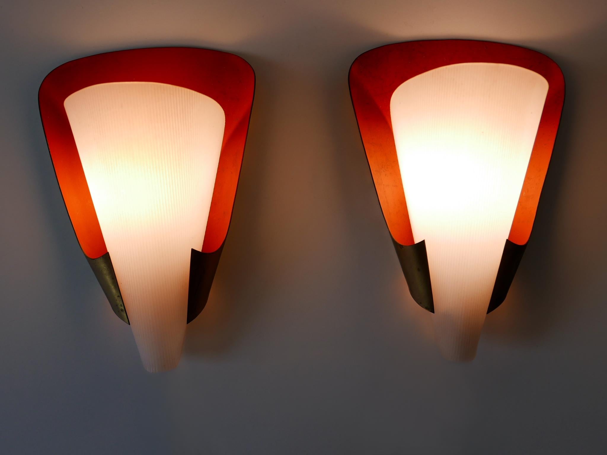 Set of two rare and elegant Mid-Century Modern sconces. Designed & manufactured in Germany, 1960s.

Executed in brass and lucite, each lamp comes with 1 x E14 / E12 Edison screw fit bulb holder, is wired, in working condition and runs both on 110