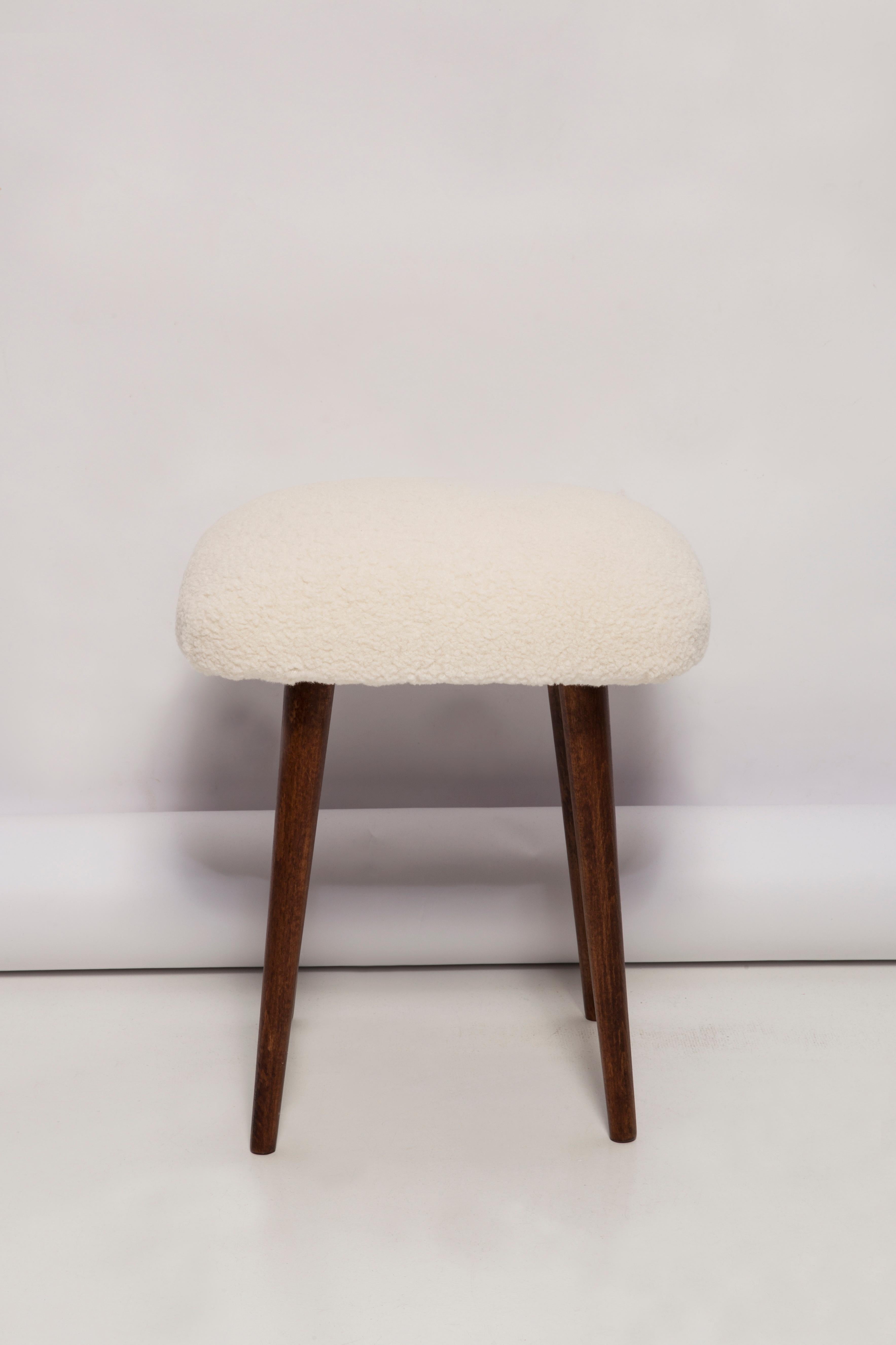 Stool from the turn of the 1960s and 1970s. Beautiful, well crafted light boucle upholstery. The stool consists of an upholstered part, a seat and wooden legs narrowing downwards, characteristic of the 1960s style. We can prepare this stool also in