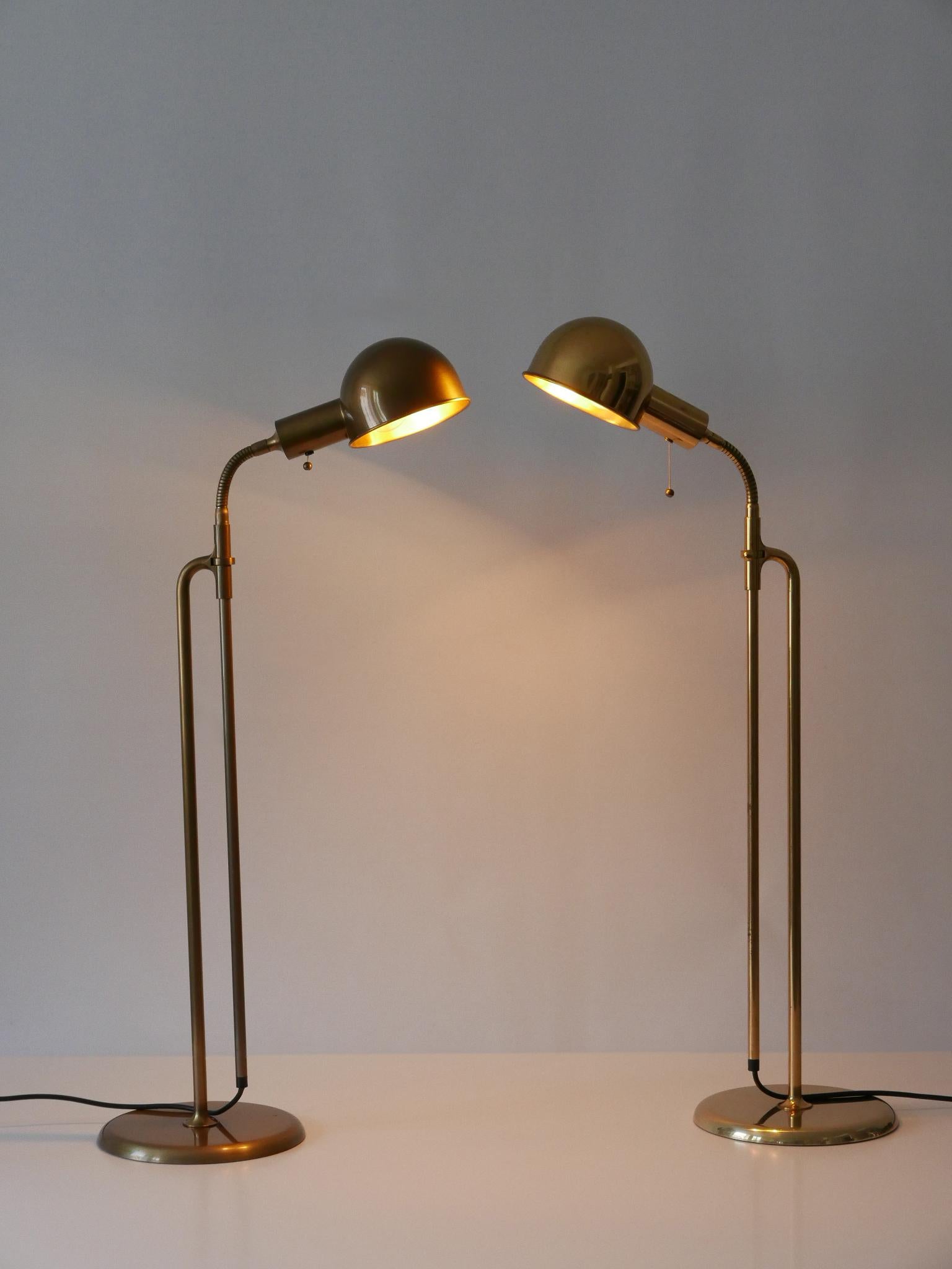 Set of two elegant and articulated floor lamps or reading lights. Model Bola. Designed and manufactured by Florian Schulz, Germany, 1970s.

The lamps are in different finishing. One is executed in polished brass, the other in bronze colored