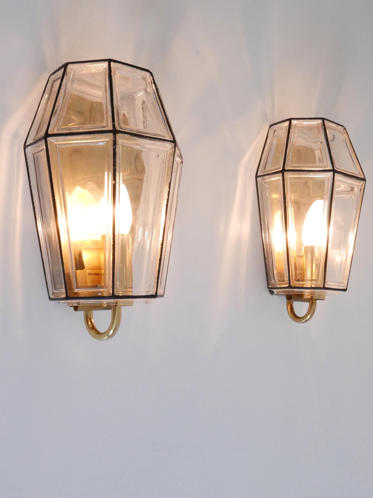 Set of Two elegant and highly decorative Mid-Century Modern sconces or wall fixtures. Designed & manufactured by Glashütte Limburg, Germany, 1960s.

Executed in glass and brass, each fixture is executed with 1 x E14 / E12 Edison screw fit bulb