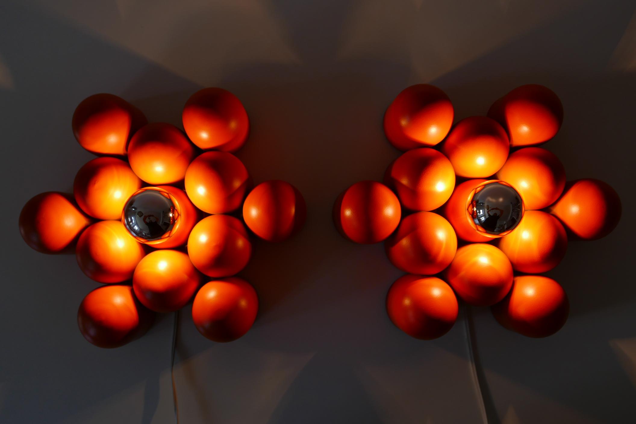 Set of two extremely rare Mid-Century Modern Sputnik wall lamps or sconces or ceiling fixtures. Designed and manufactured probably in Germany, 1960s.

The lamps are executed in orange enameled aluminum and each lamp needs 1 x E27 Edison screw fit