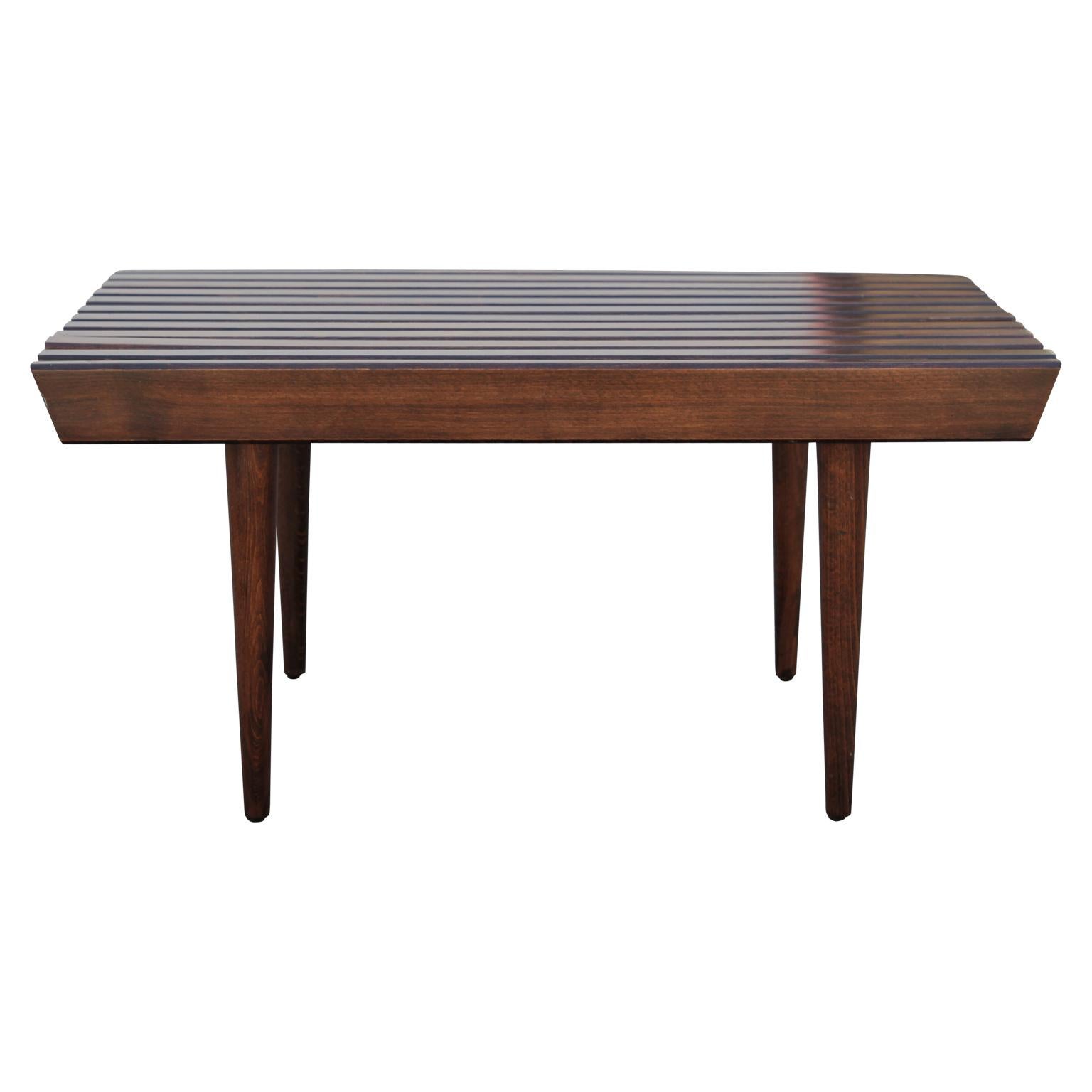 Very sharp wooden slat bench in the style of George Nelson. 
The iconic benches are functional as a coffee table or a side table.