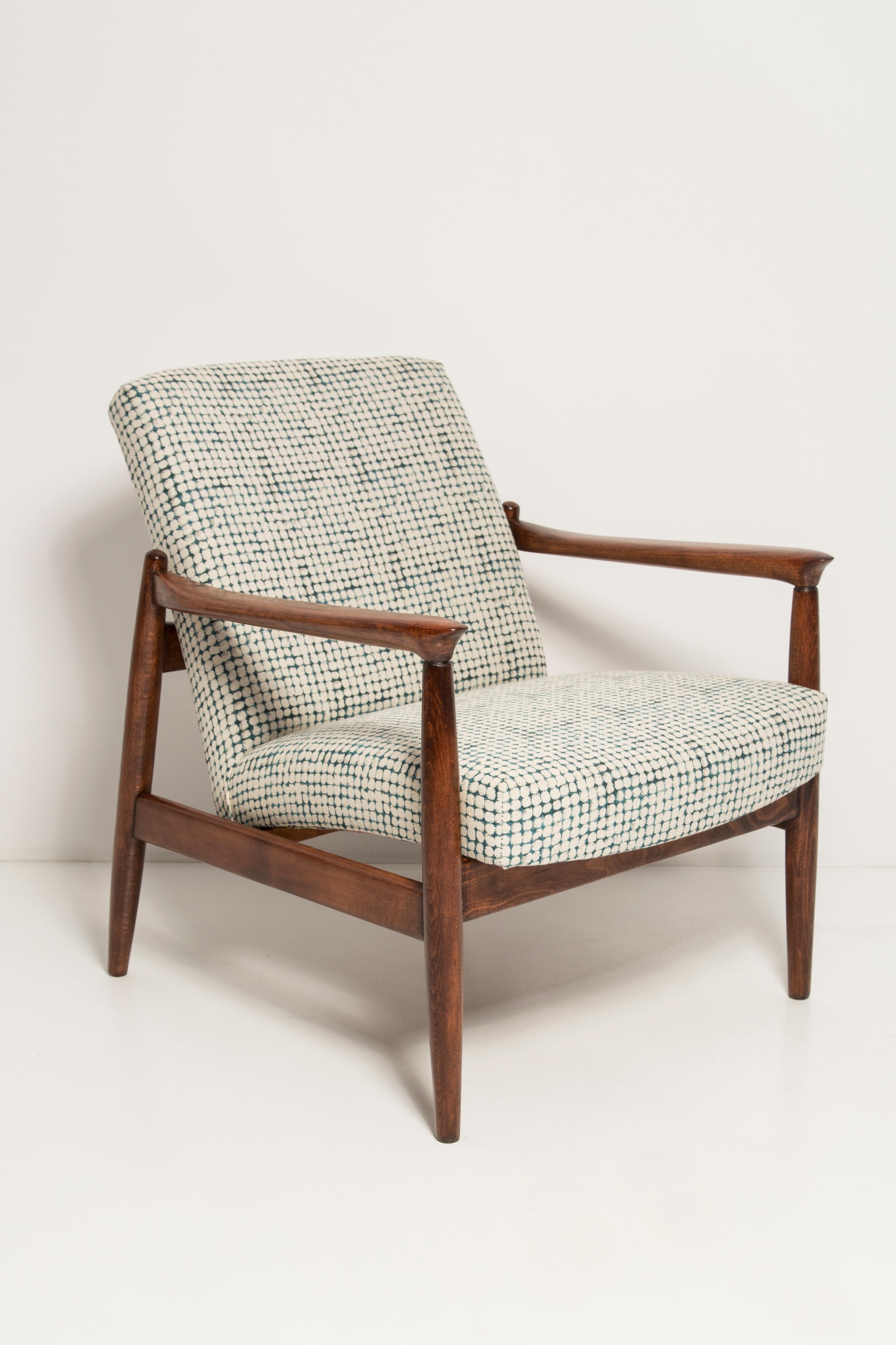 Beautiful armchair and foot stool, designed by Edmund Homa. The armchair was made in the 1960s in the Gosciecinska Furniture Factory from solid beechwood. The GFM type armchair is regarded one of the best polish armchair design from the previous