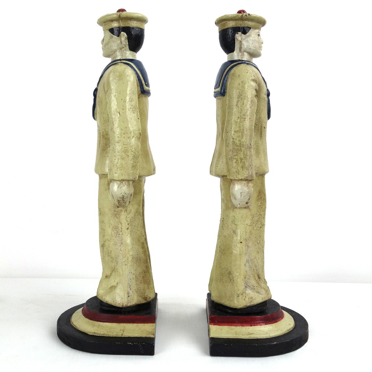 These two masculine and muscular sailors make sure that your book collection stays in an upright position. 
The guys are made of cast iron making them pretty heavy. 
They once were painted in the colors red, white, blue and black. 
We figure that