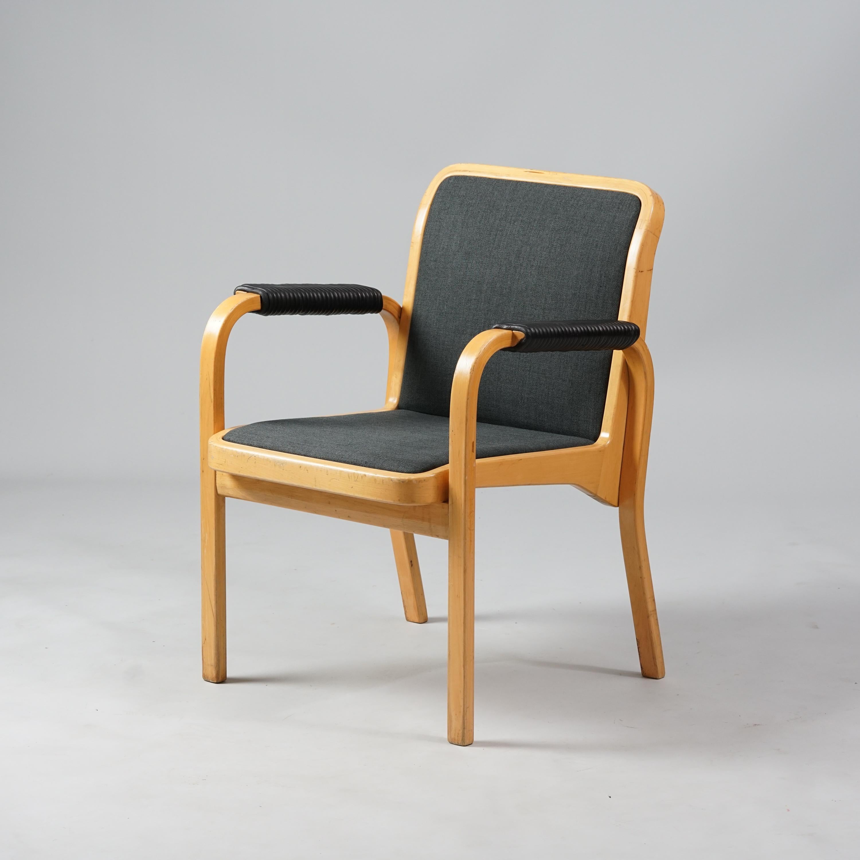 Set of two model E45 armchairs, design Alvar Aalto, manufactured by Artek, 1960/1970s, birch frame, leather details on the armrests, fabric upholstery. Good vintage condition, minor wear and patina consistent with age and use. The armchairs are