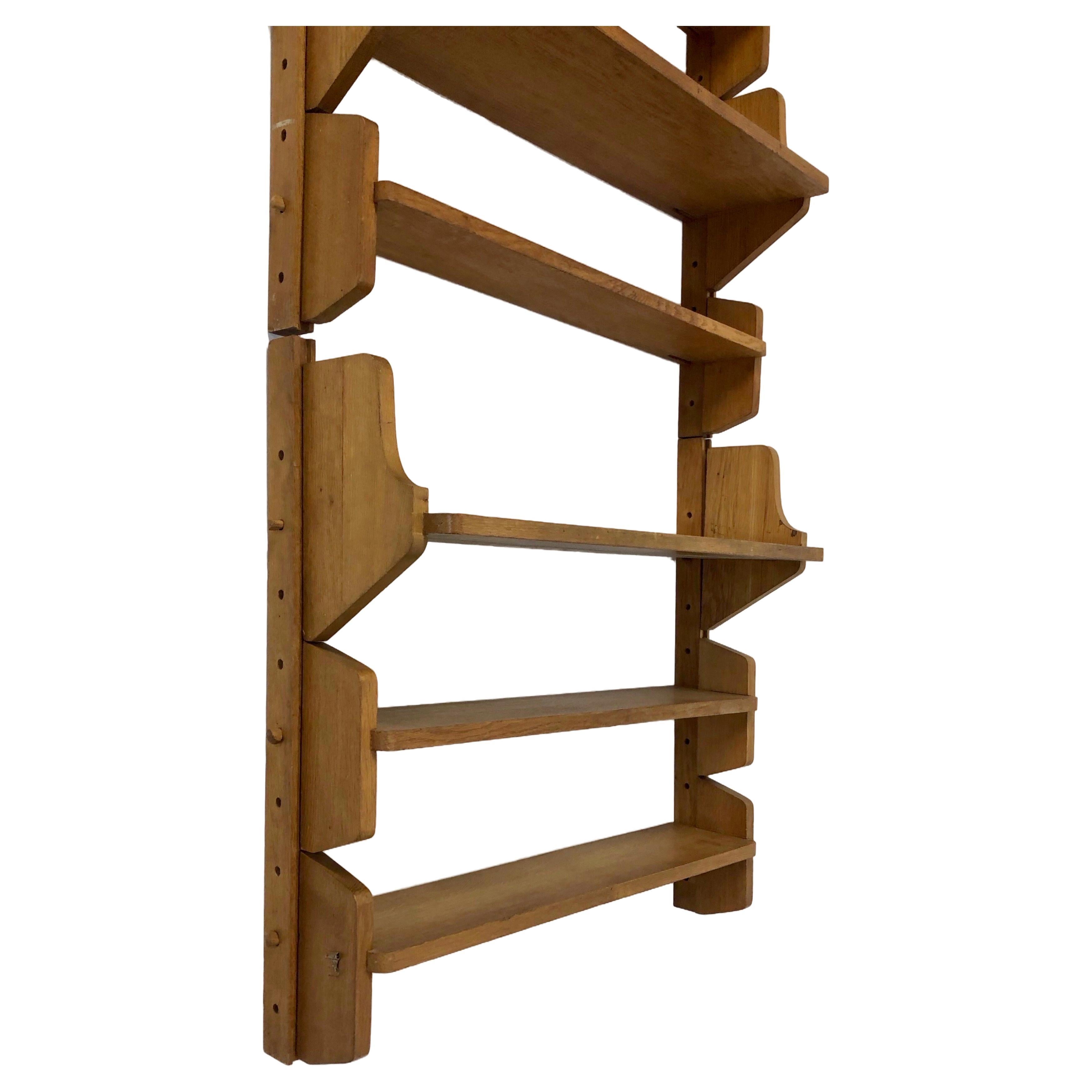 A set of two modular shelves designed by Emile Seigneur, a designer of the French reconstruction era. 

The two shelves are independent but are shown here stacked on top of each other. Each shelf consists of two vertical oak supports and three