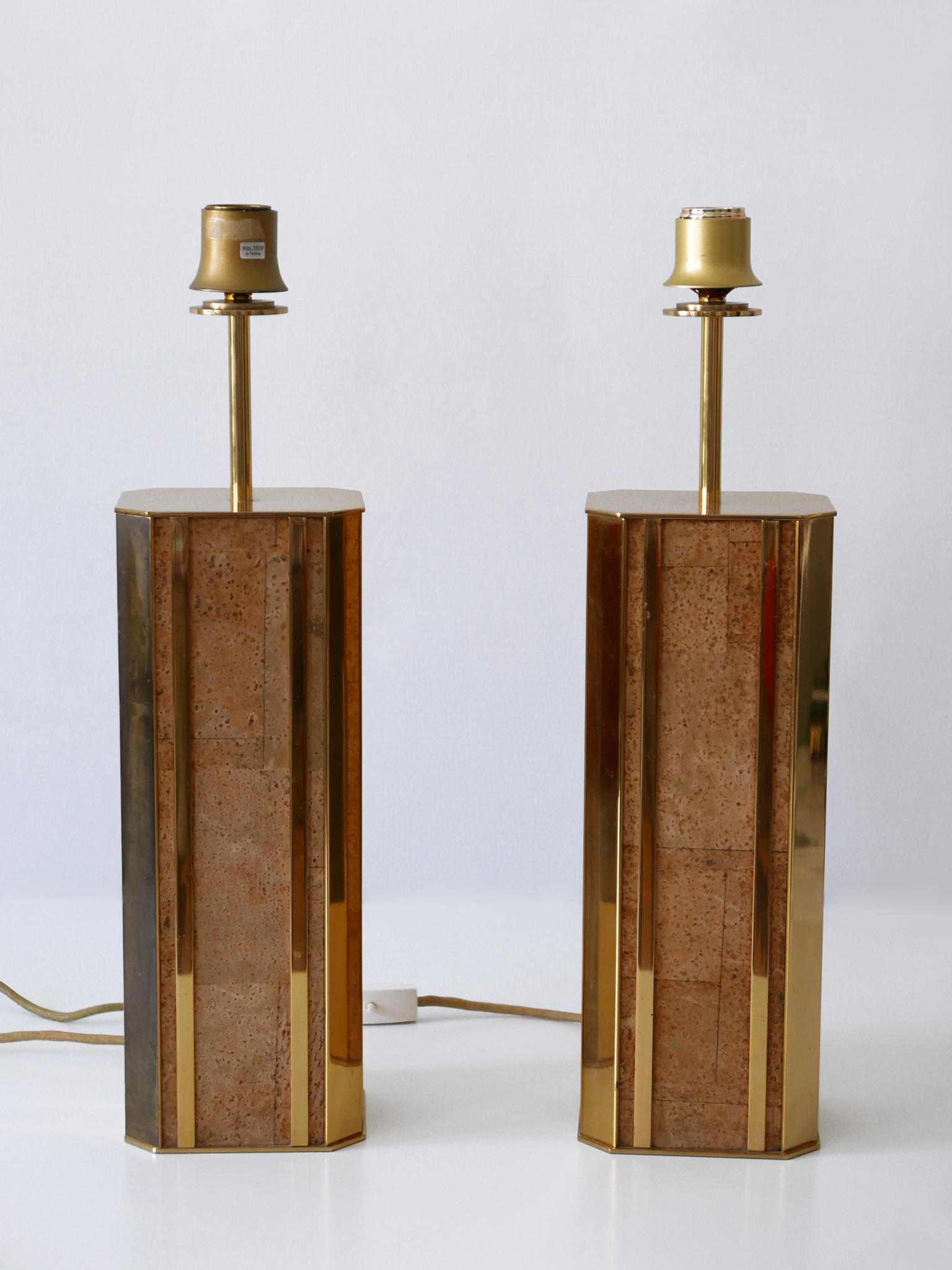 Set of two monumental and extremely rare Mid-Century Modern table lamps in heavy, massive brass and cork. Designed and manufactured by Vereinigte Werkstätten, 1960s, Germany.

These sculptural table lamps are executed in massive brass and cork. Each