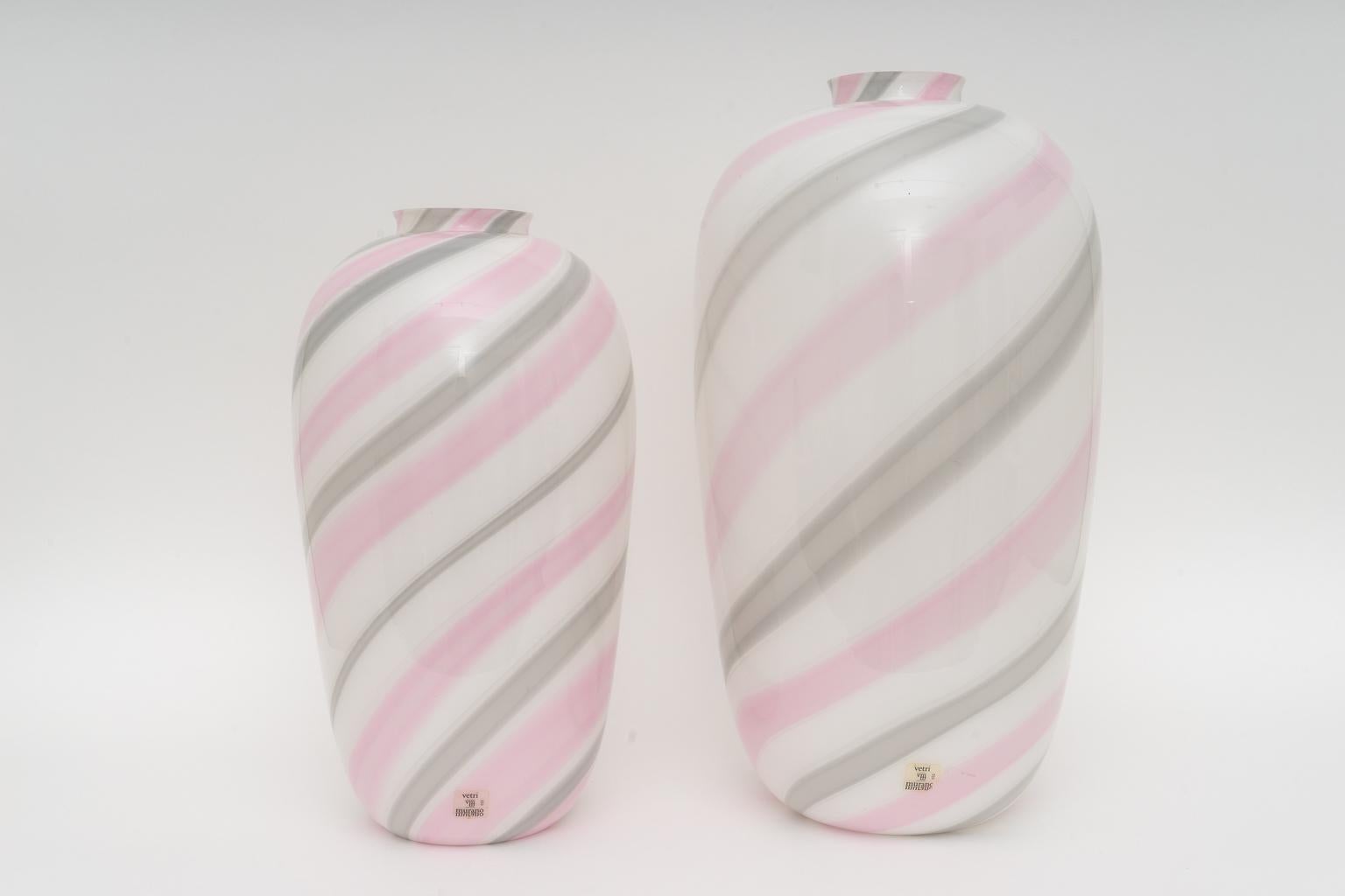 This stylish and chic set of two Murano glass vases were created in the 1980s by Vetri and were acquired from a Palm Beach estate. The can be used to hold your floral arrangements and simply as objects of beauty.