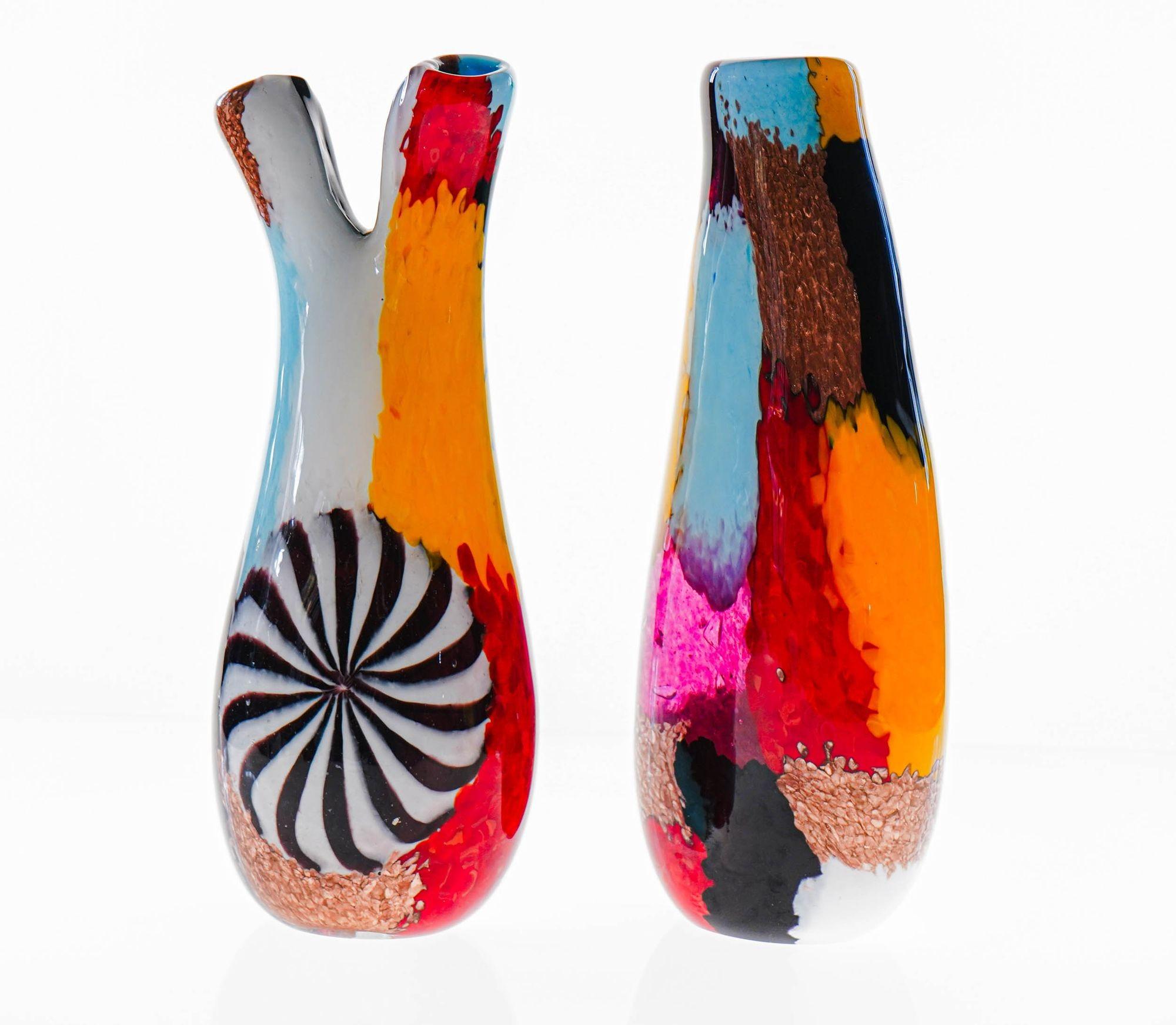 Splendid pair of vases made in Murano in the style of the Oriente series of Dino Martens.
One vase has two branched mouths. The other single mouth almond shape. Uses same technique developed by Dino Martens at Aureliano Toso with disc made of canes