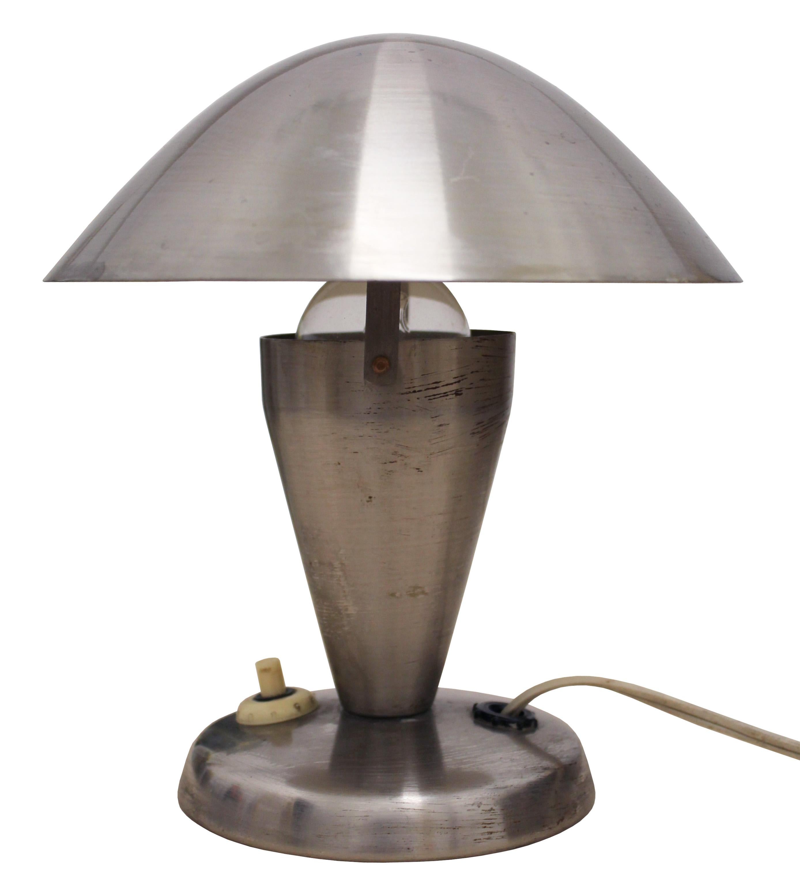 A pair of steel midcentury table lamps by the iconic Czech lighting designer Josef Hurka. These lights were produced in the early 1950s by the Napako Company and their design is strongly influenced by the pre-war modernist aesthetic. The lamp shades