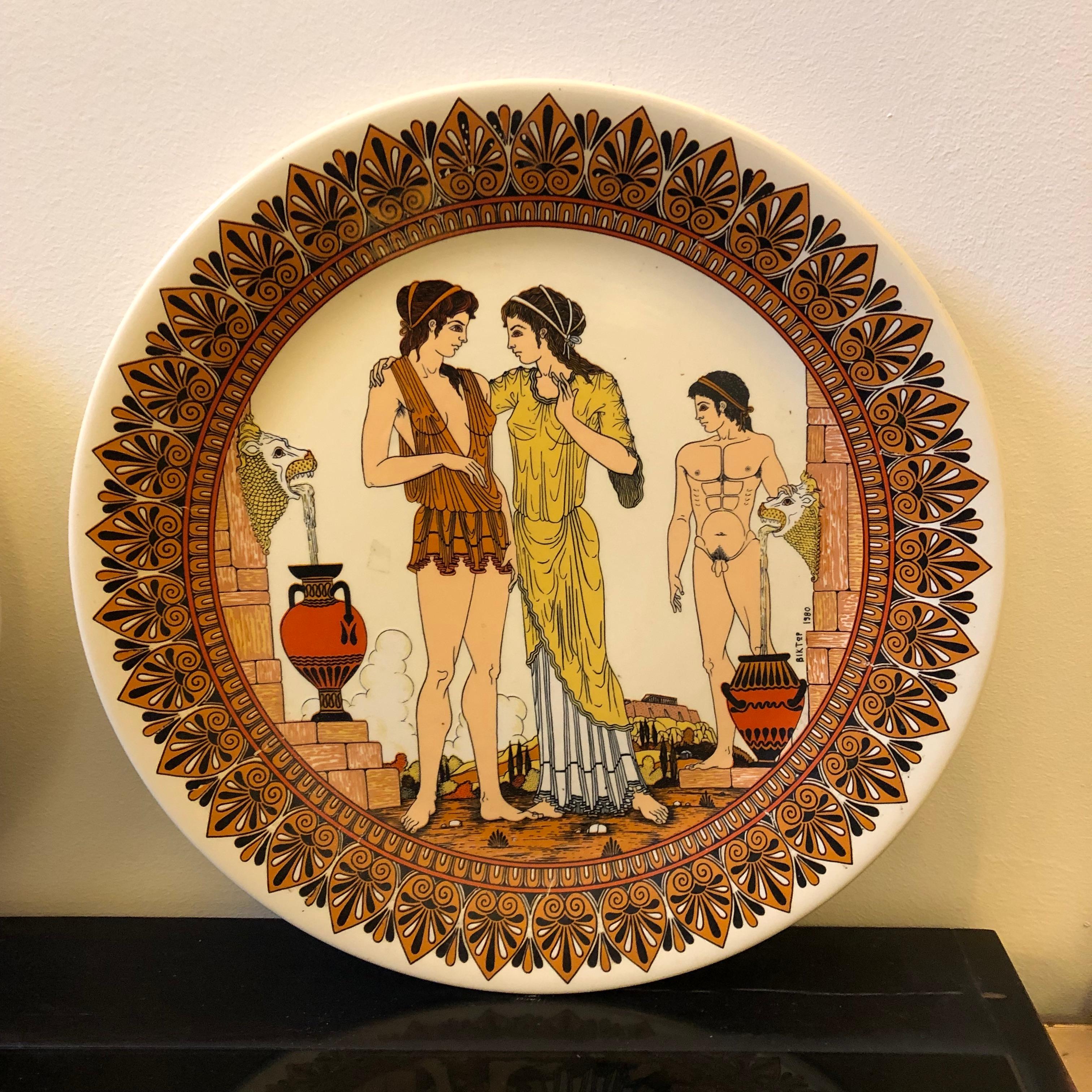 Two hand painted ceramic mural plates made in Greece, signed by Victor, depicting neoclassical scenes of antique Greece.