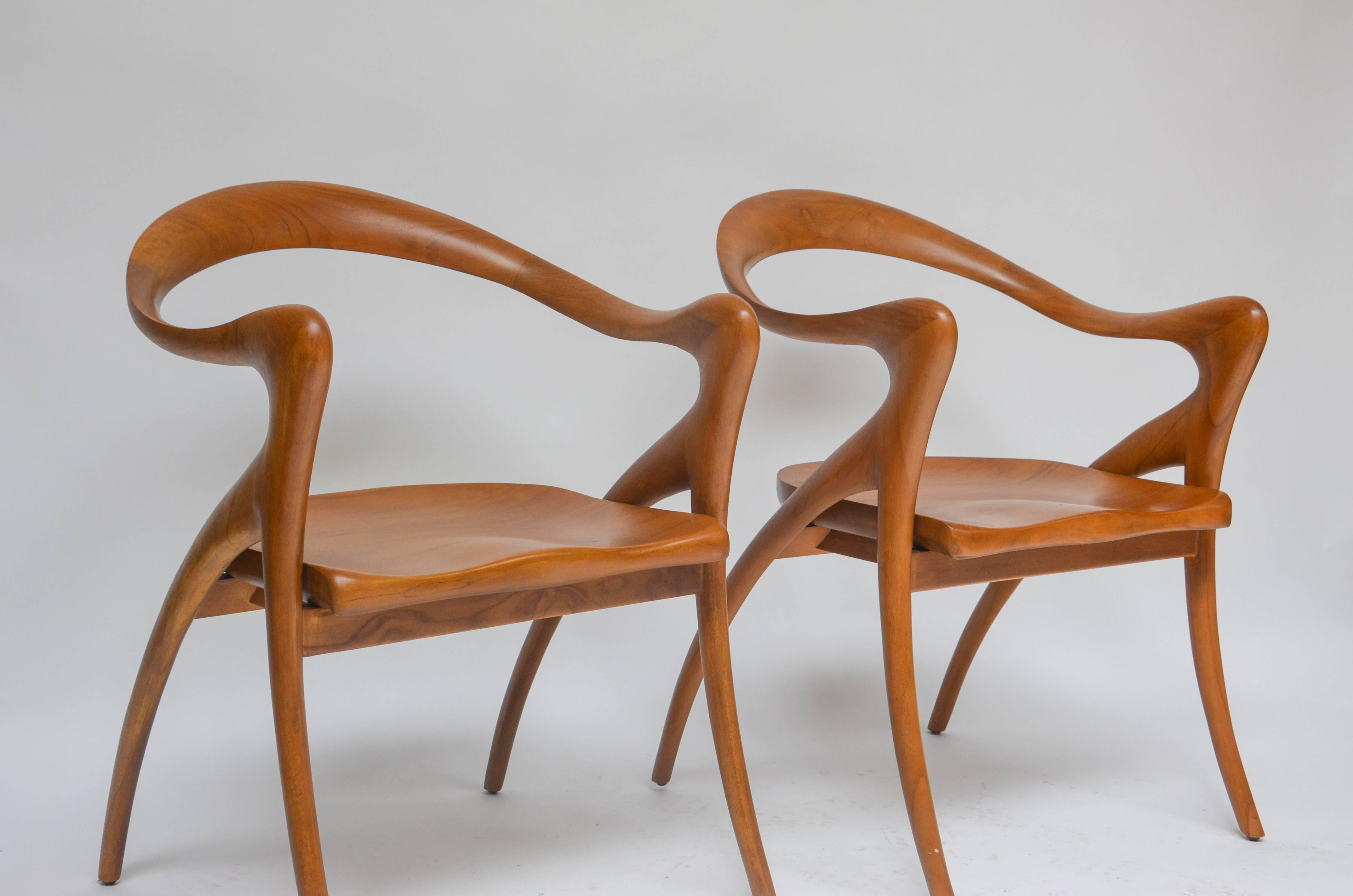Set of two organic neo-vintage, hand carved, teak armchairs. Designed by Olivier De Schrijver. Excellent condition.