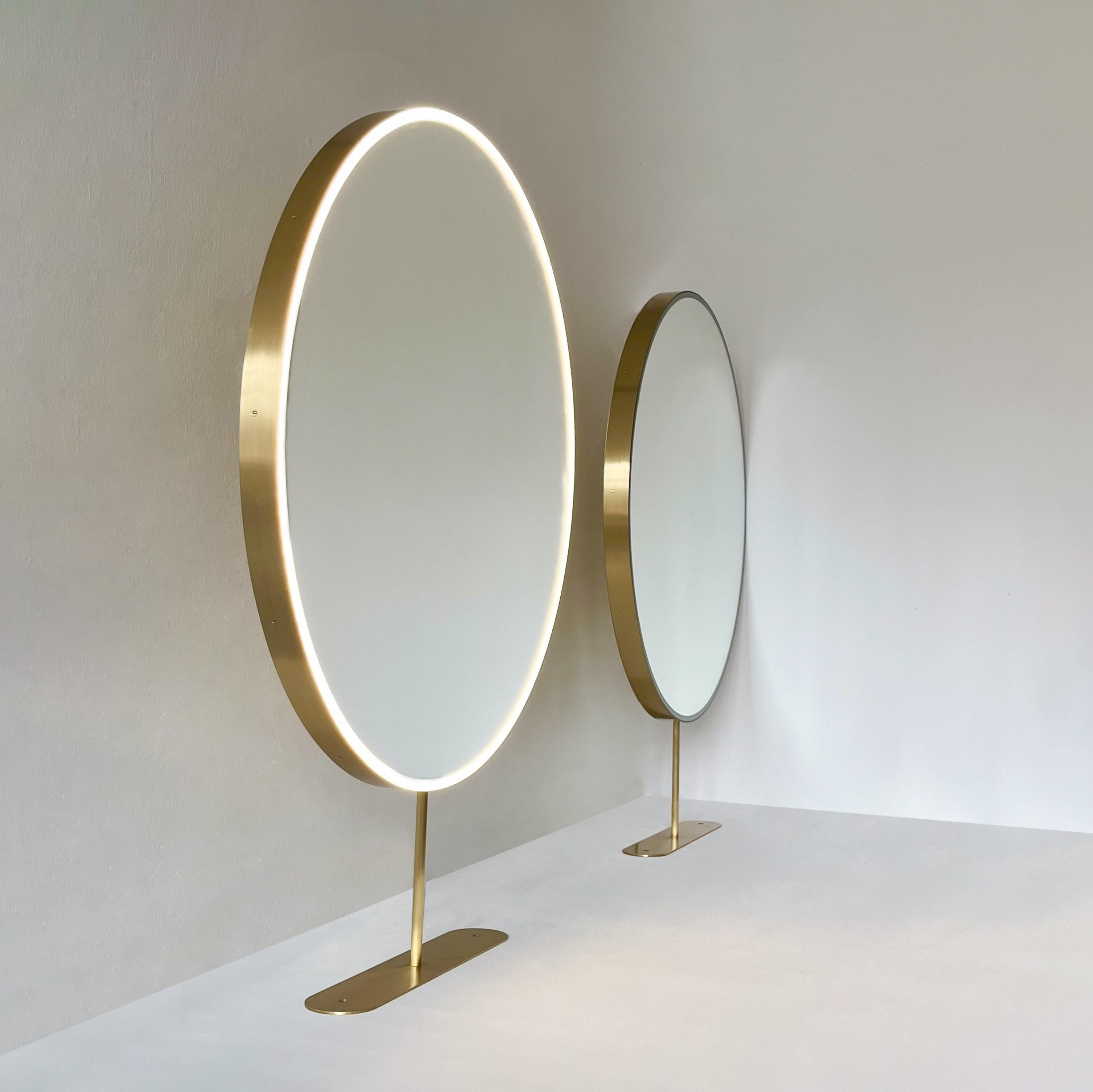 Set of two contemporary front illuminated Orbis™ countertop round mirror with a minimalist handcrafted brushed brass frame, arm and counter plate. Designed and handcrafted in London, UK. These mirrors are fully customisable to suit the specific