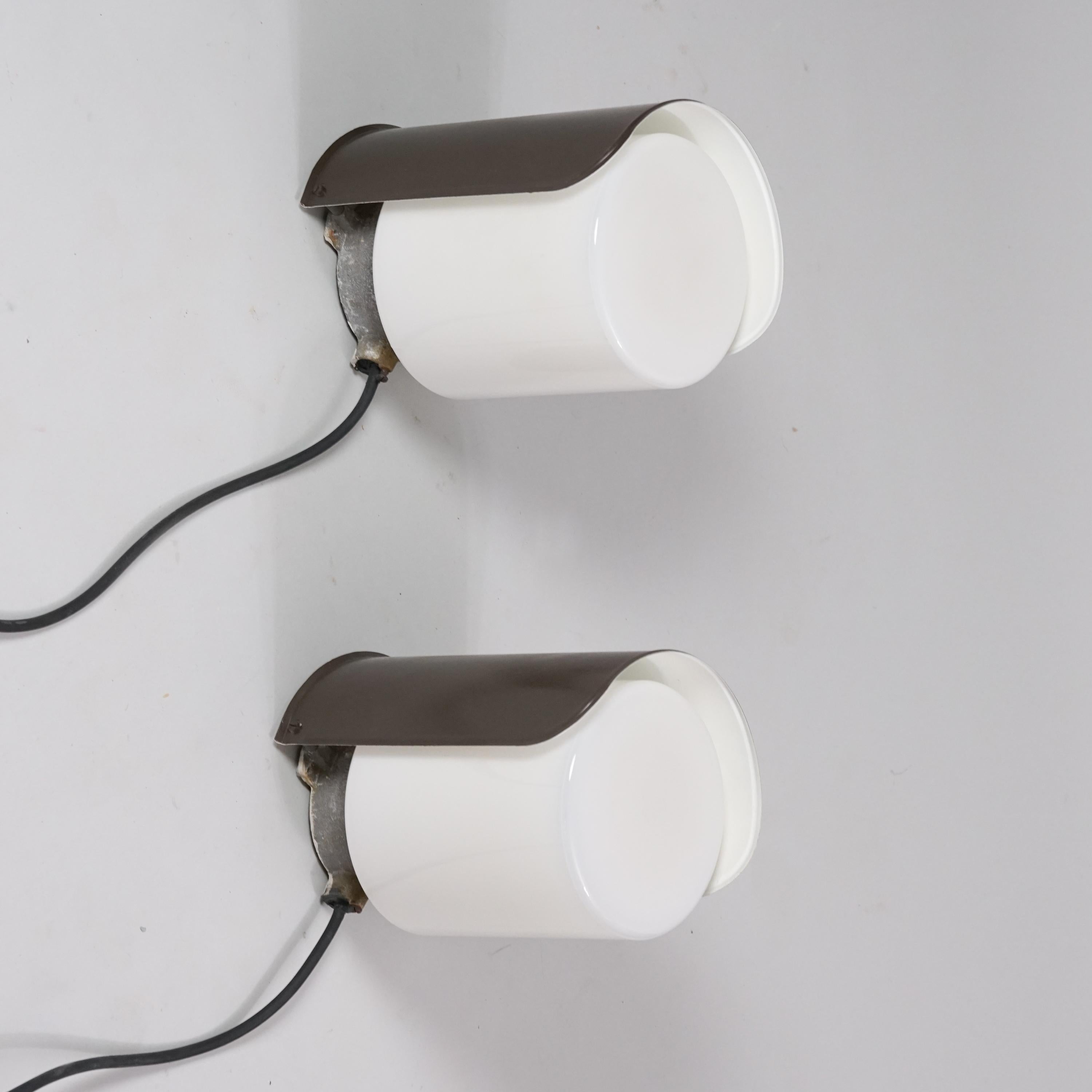 Set of two outdoor wall lights, design by Paavo Tynell, manufactured by Idman Oy, 1950s. Painted metal and milk glass. Good vintage condition, patina consistent with age and use. The wall lights are sold as a set. 

Paavo Tynell (1890-1973) is one