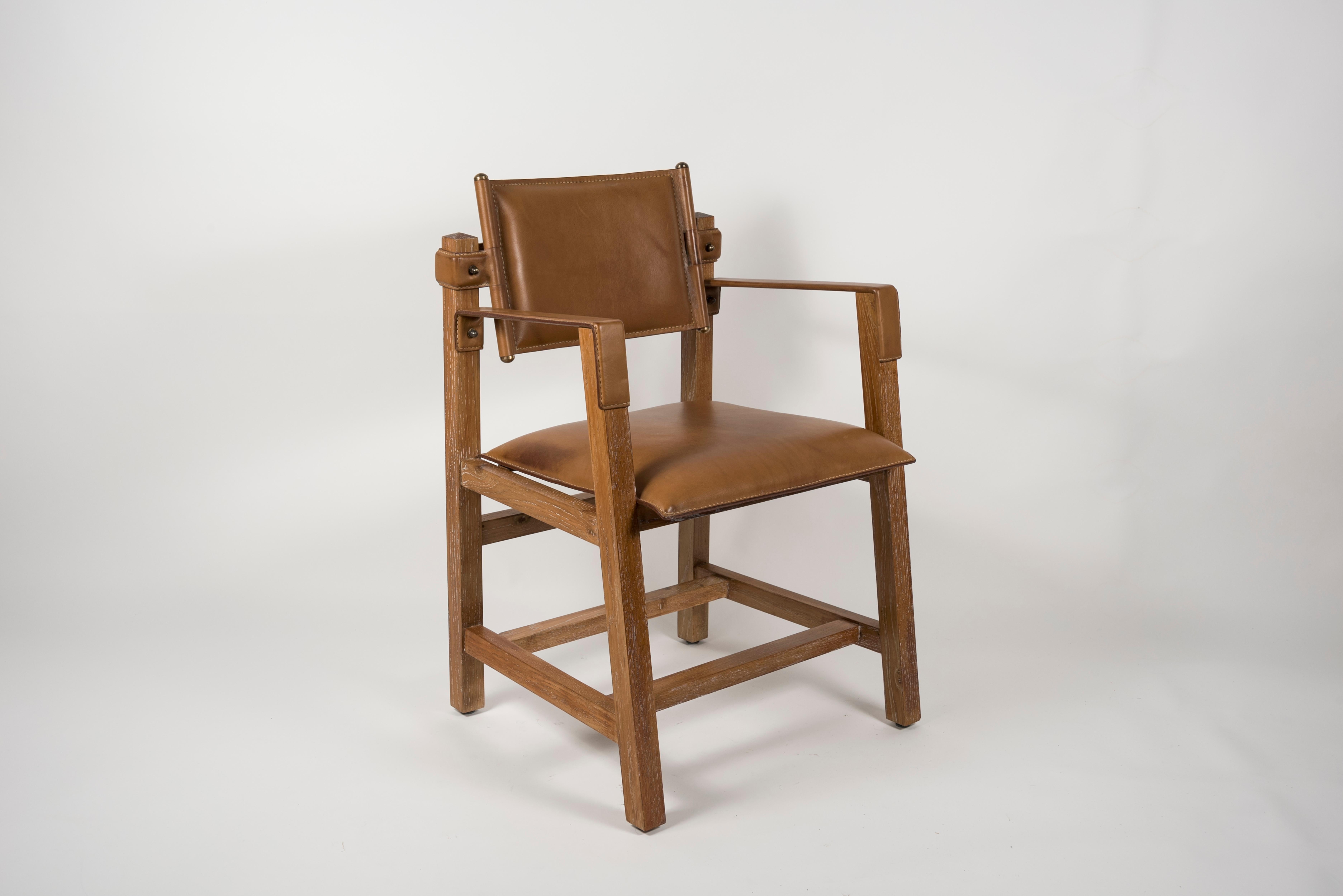 Rare paire de fauteuils en chêne et cuir surpiqué conçue par Jacques Adnet
Peut être vendu par paire
France
1950's.
 