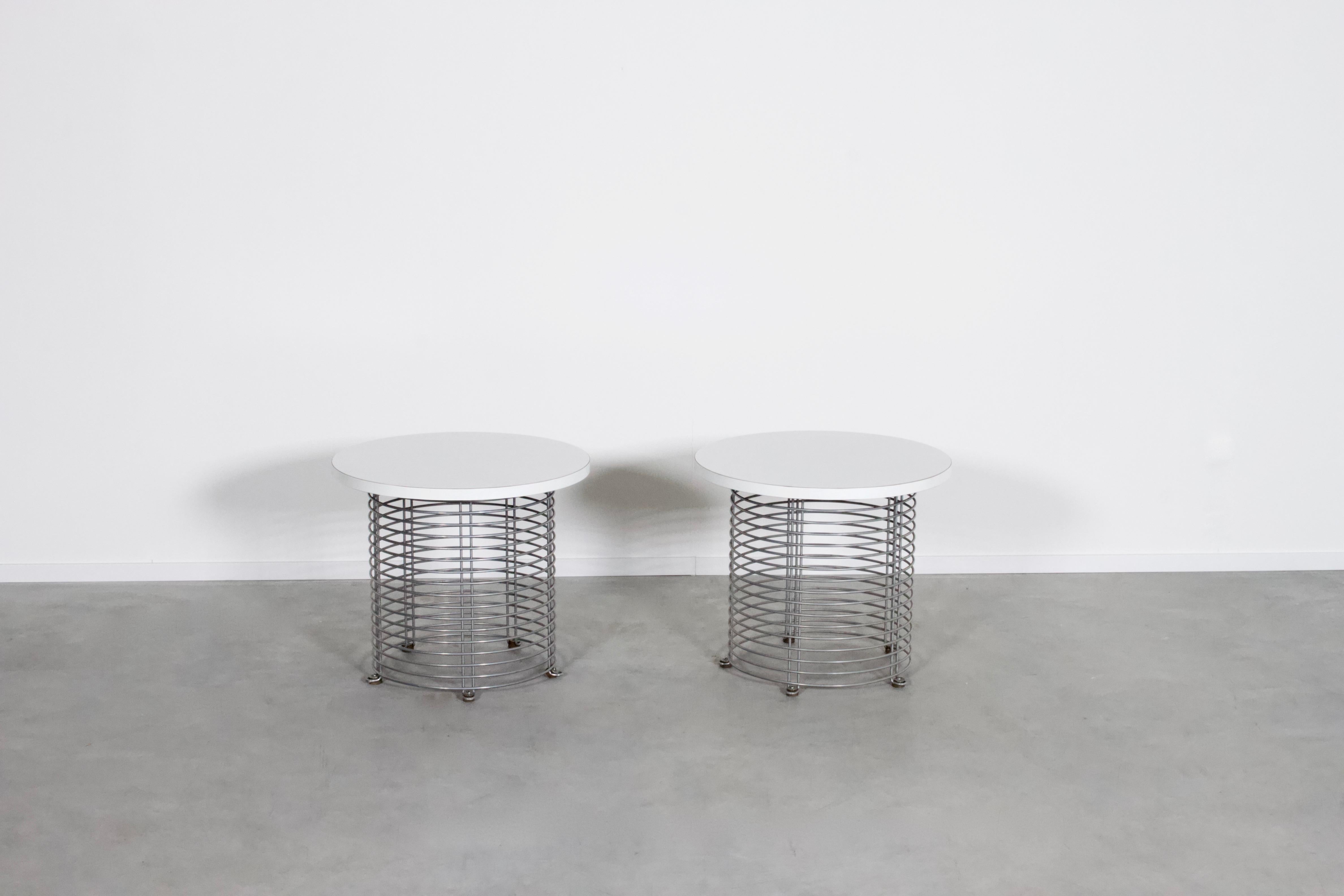 Set of 2 Pantonova end/coffee tables in very good condition.

Designed by Verner Panton in 1971. 

Produced by Fritz Hansen, Denmark

The tables consist of parallel chromed wire rods and a white Formica top.

The Pantonova series were designed and